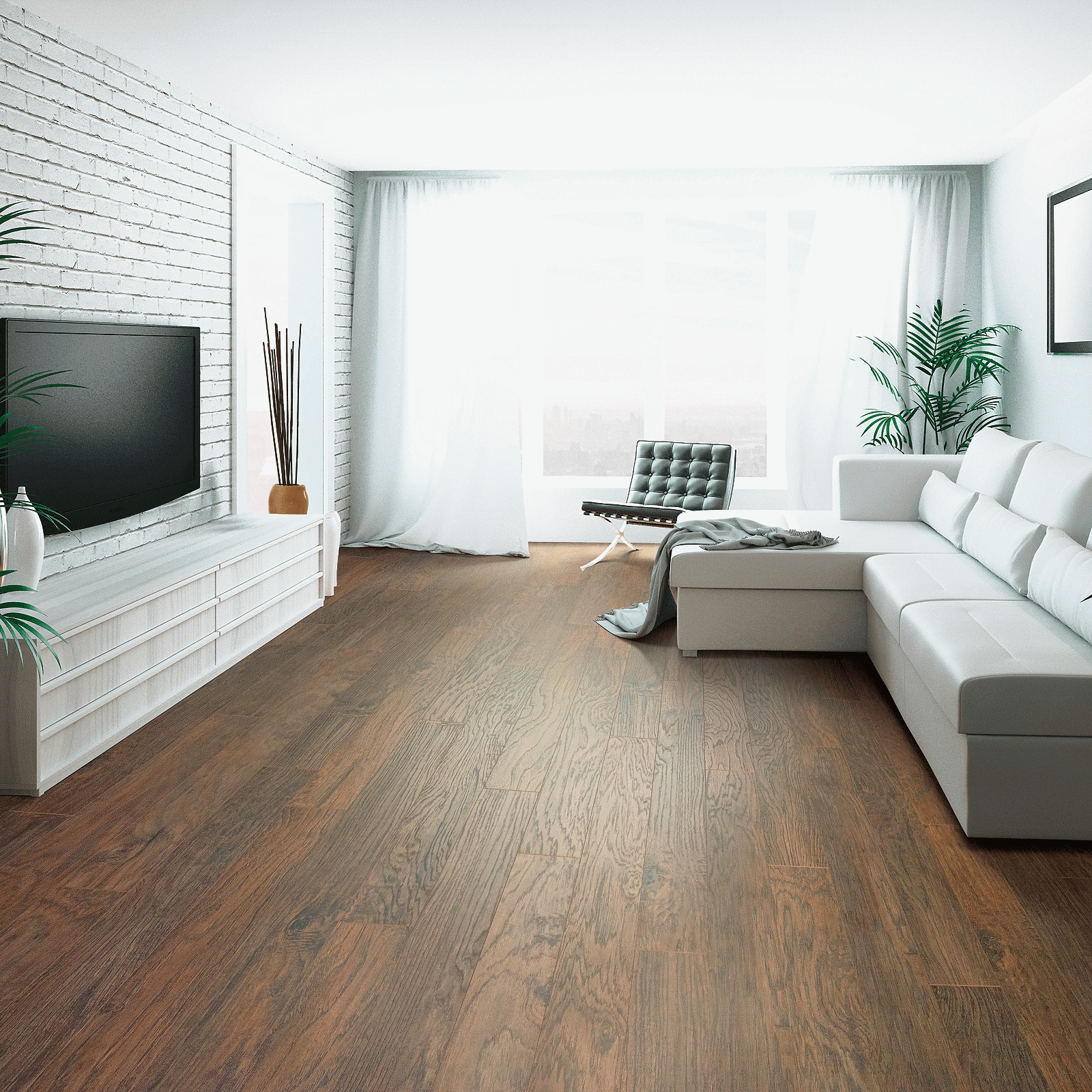 A living room with white furniture and wood floors.