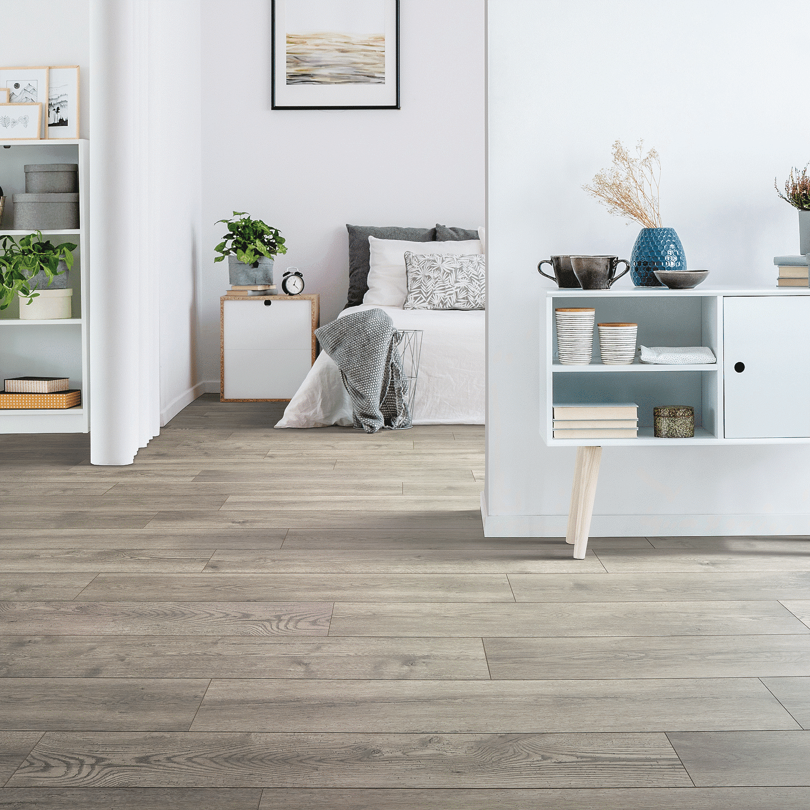 A living room with wooden floors and white walls.