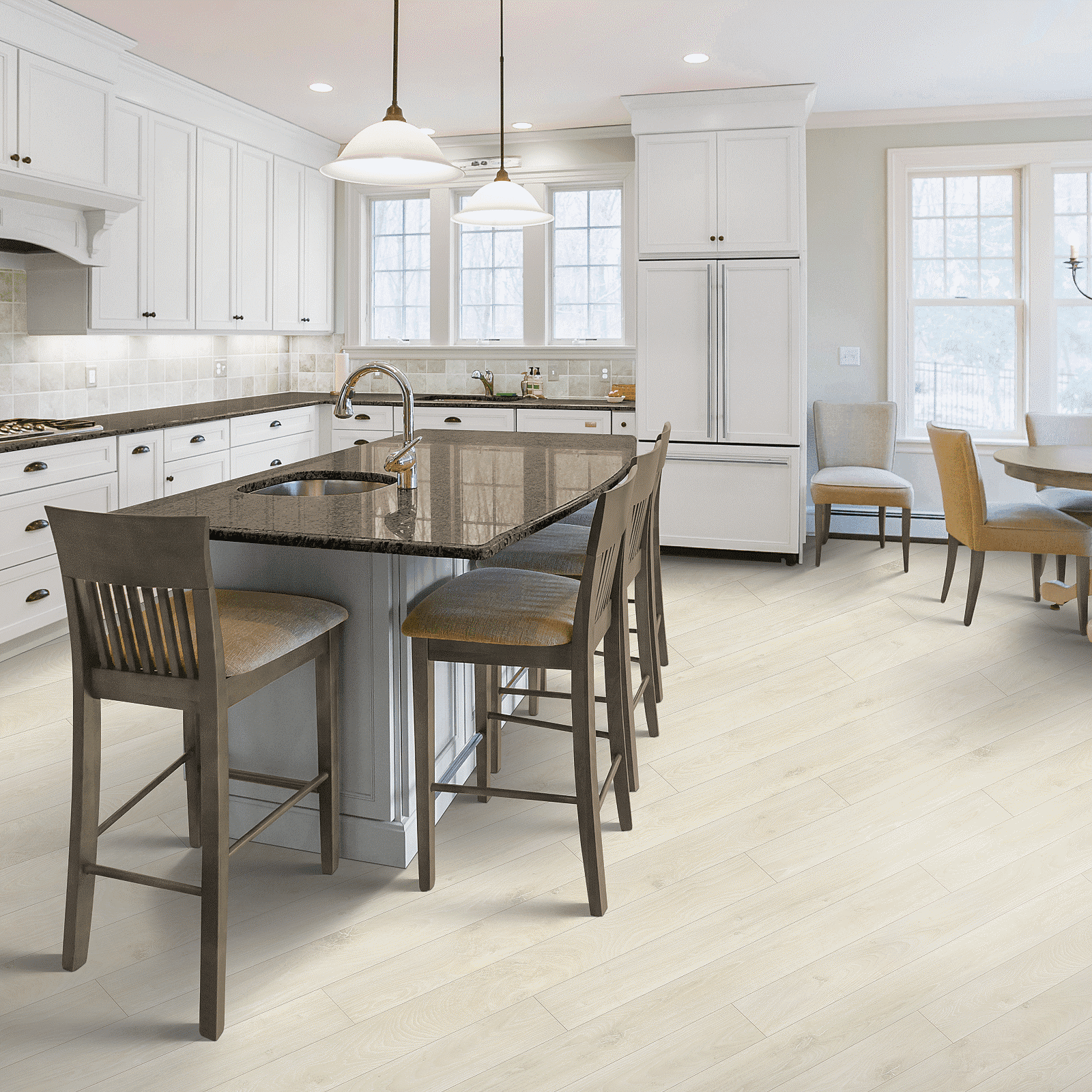 A kitchen with white cabinets and wooden floors.