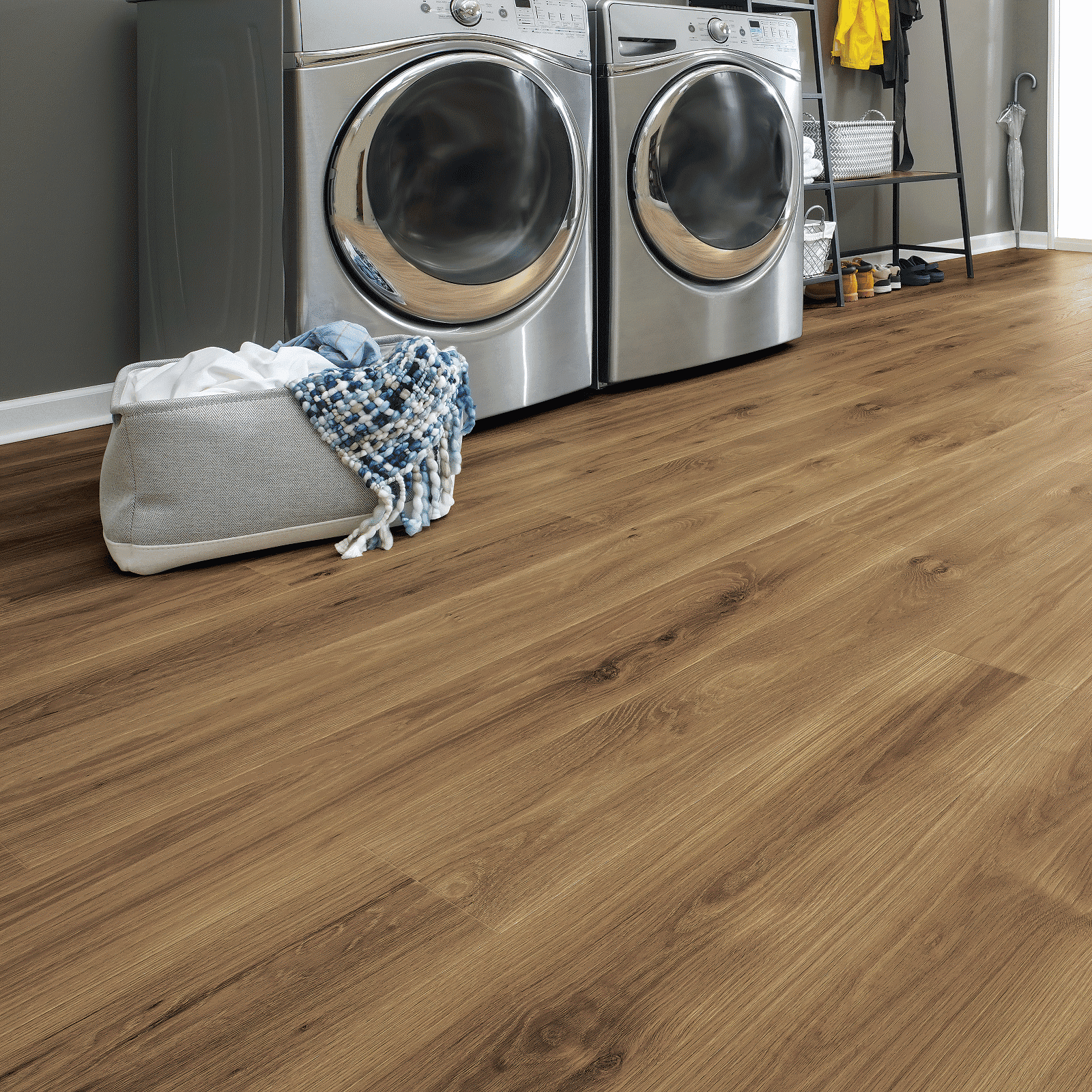 A laundry room with two machines and a bag.