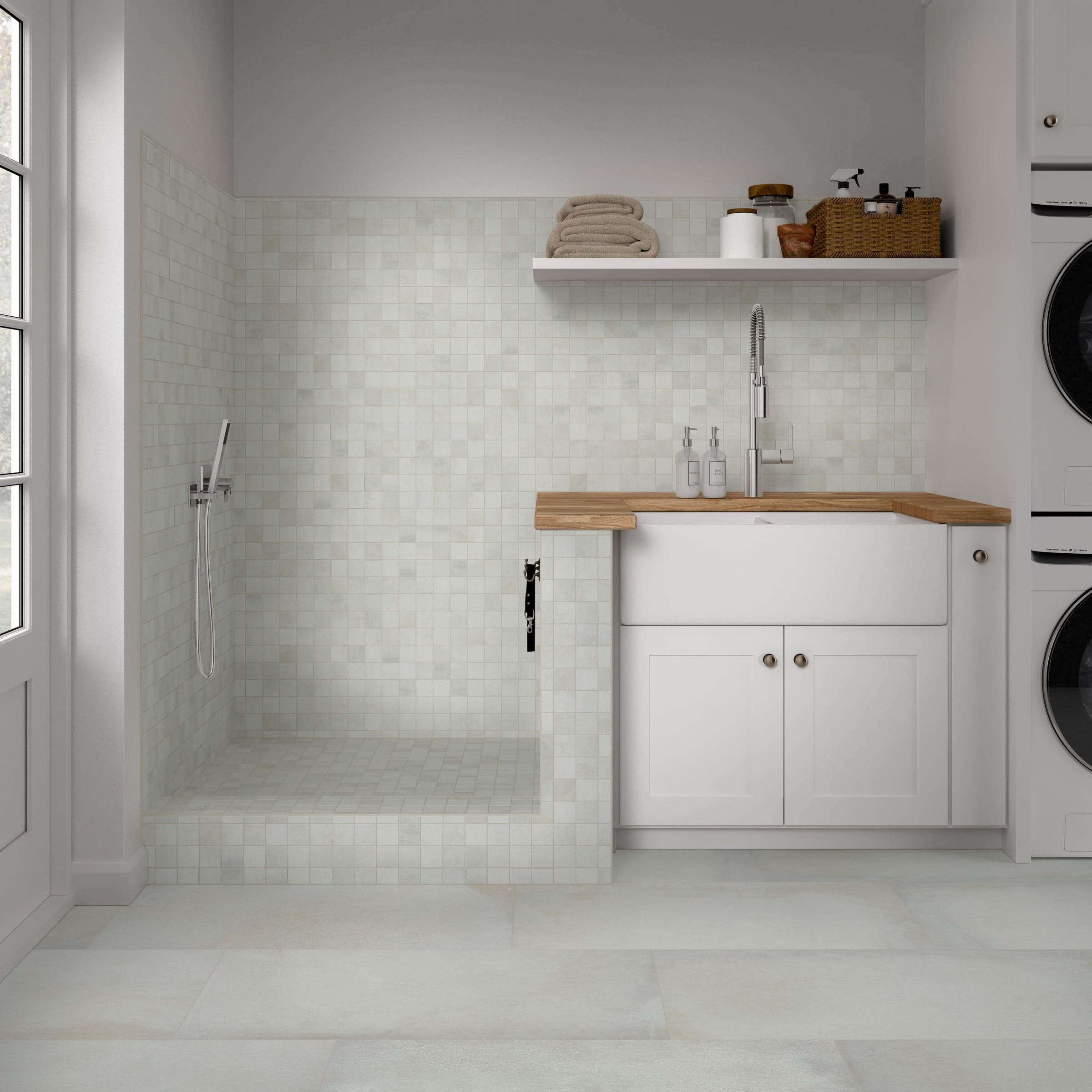 A white room with a sink and washer in it