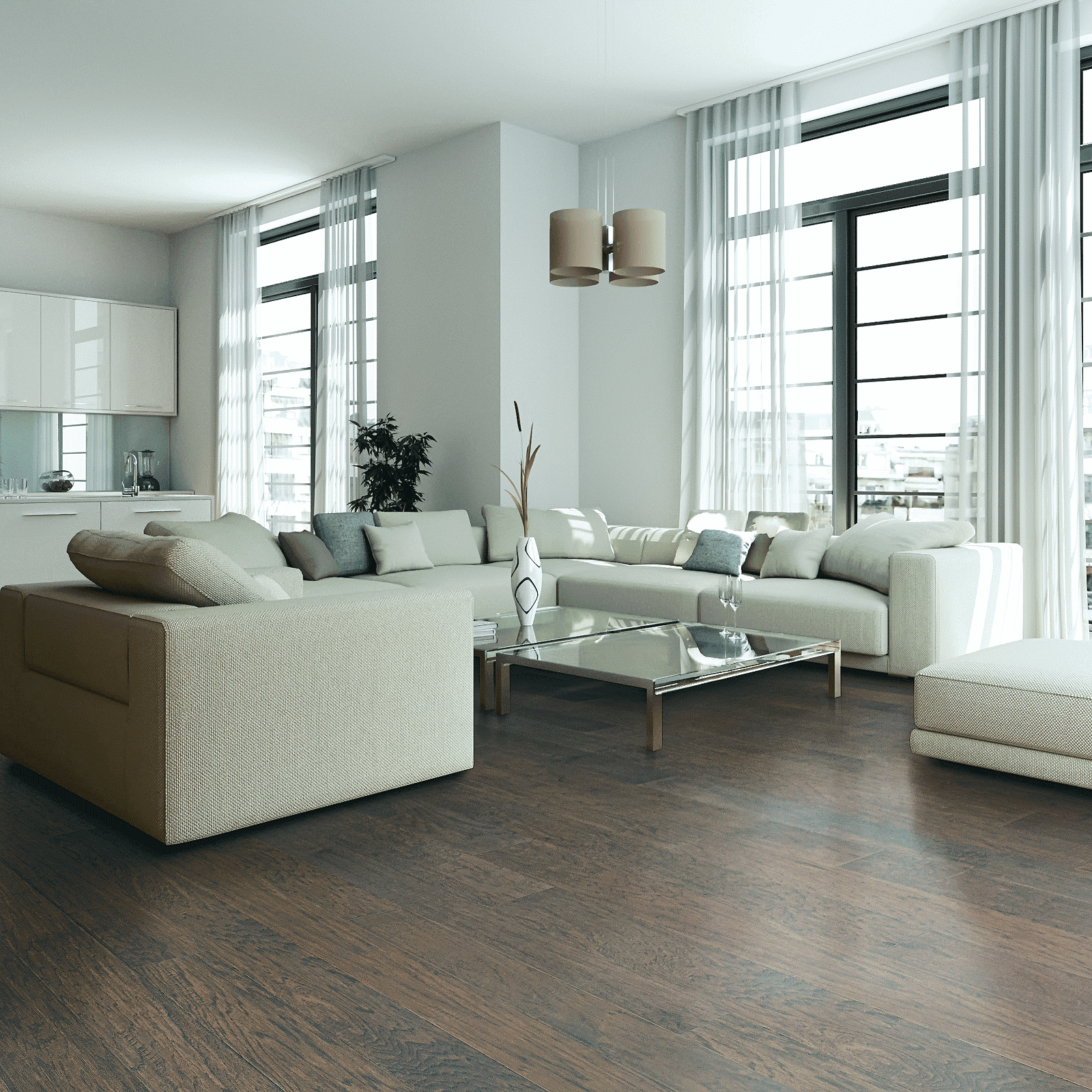 A living room with white furniture and large windows.