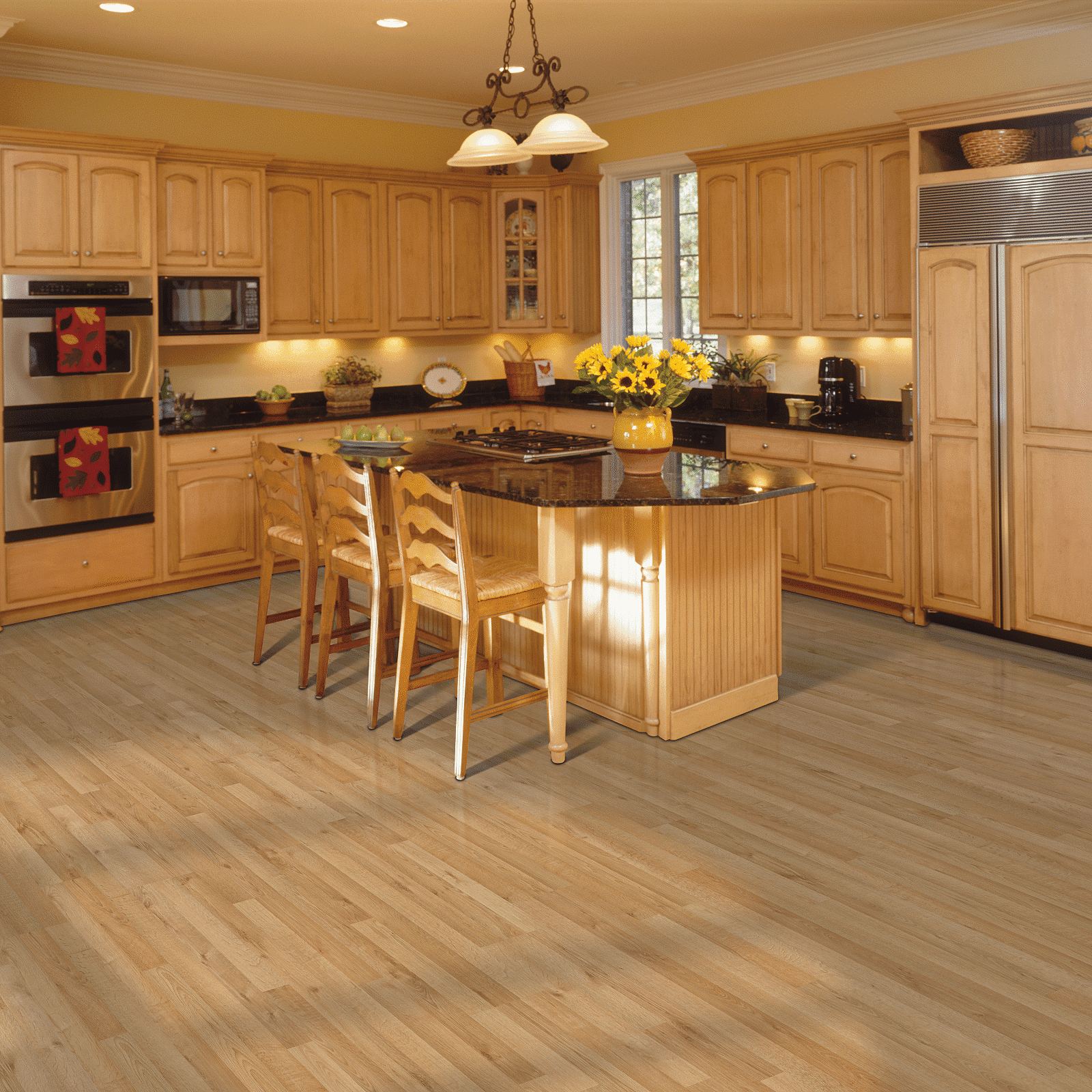 A kitchen with wooden floors and cabinets