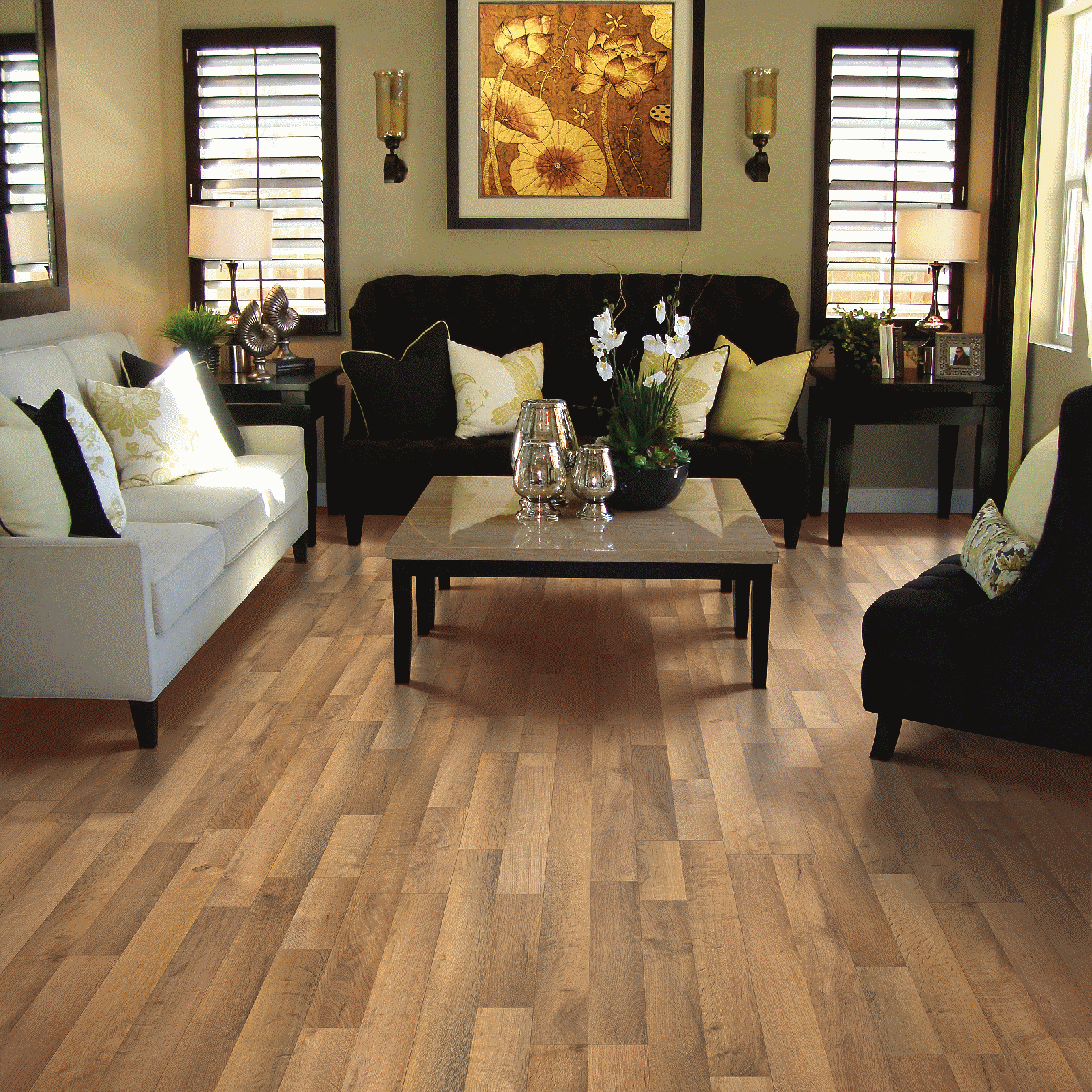 A living room with furniture and a painting on the wall.