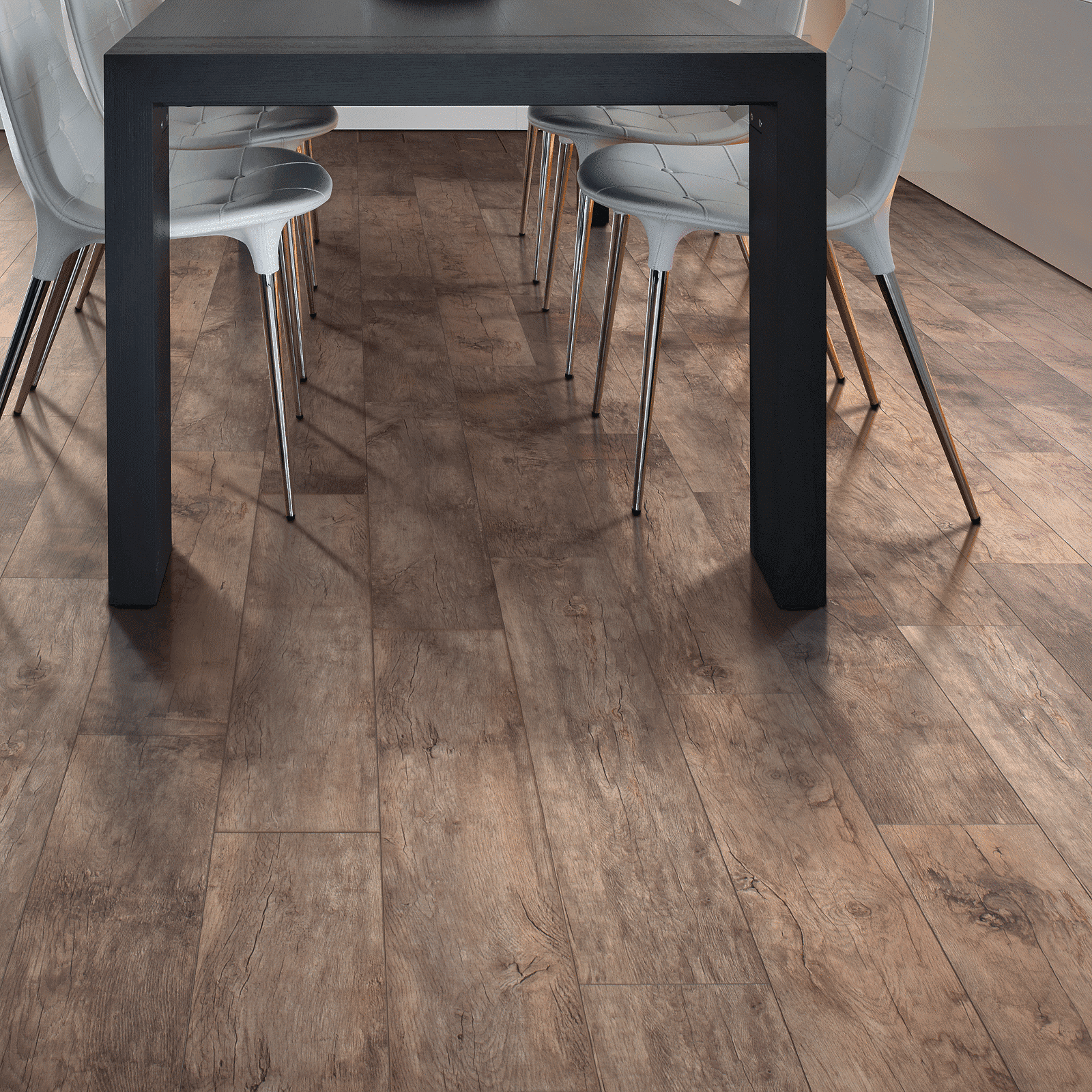 A dining room table with chairs around it.
