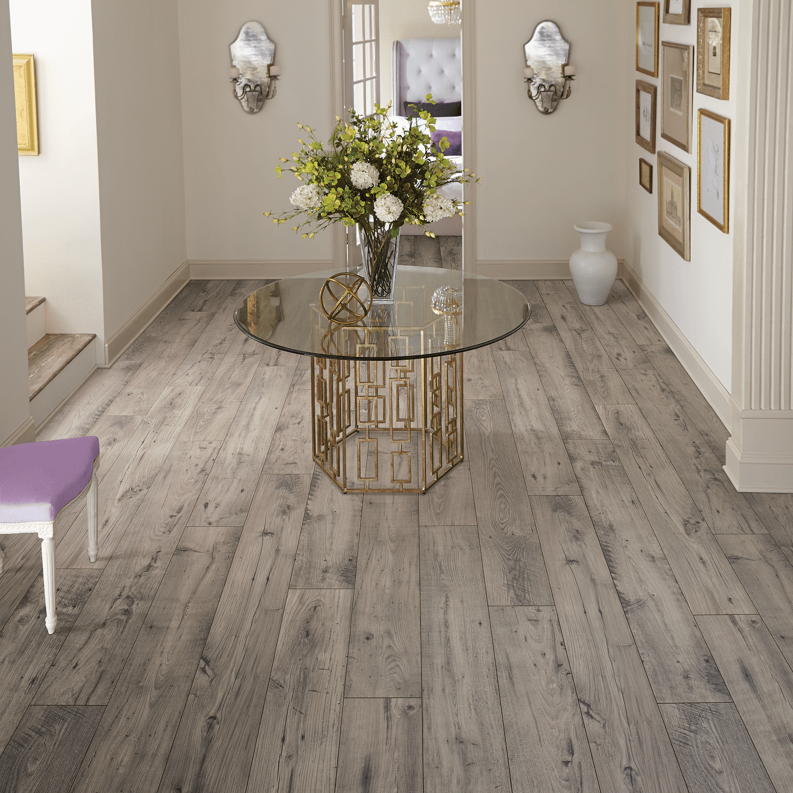 A room with a table and chairs, flowers in the center of it.