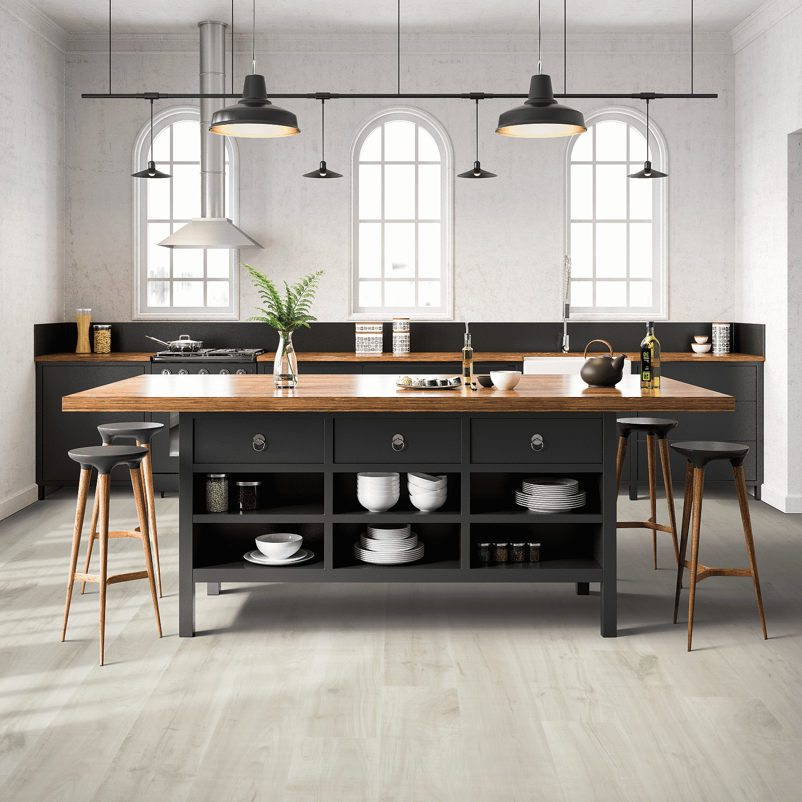 A kitchen with a large island and black cabinets.
