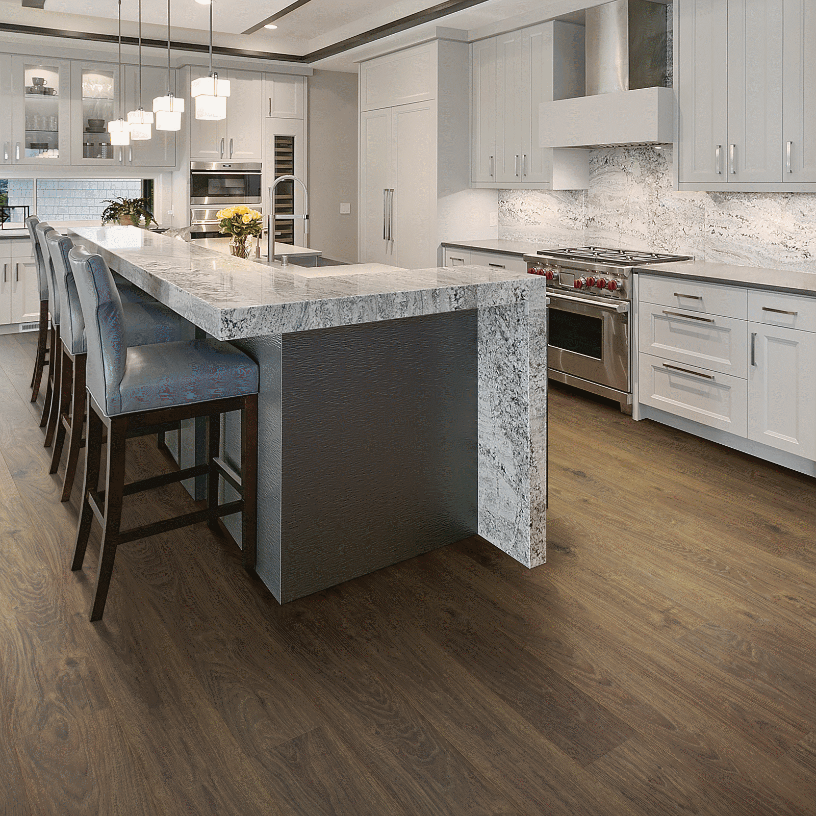 A kitchen with a large island and white cabinets.