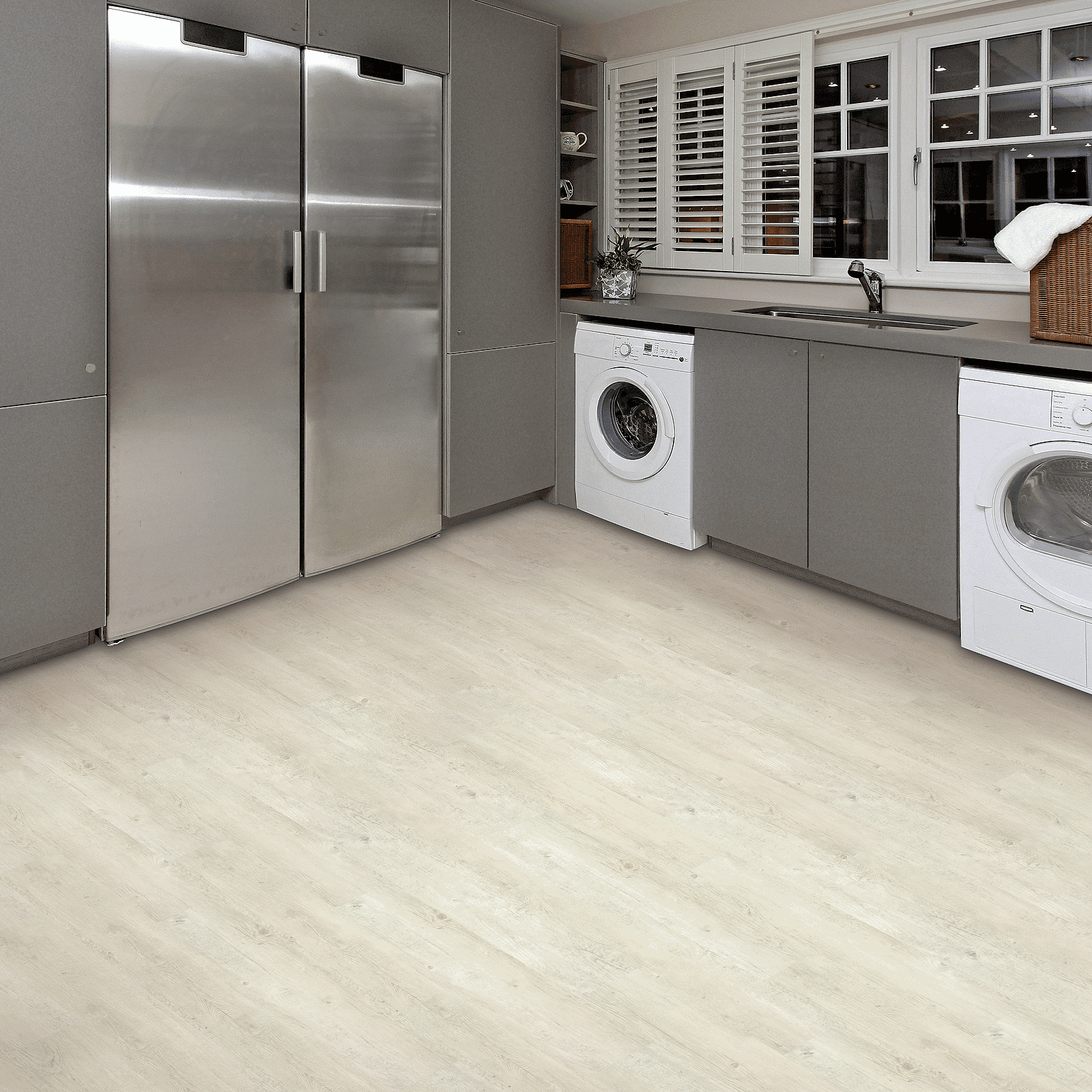 A kitchen with stainless steel appliances and white cabinets.