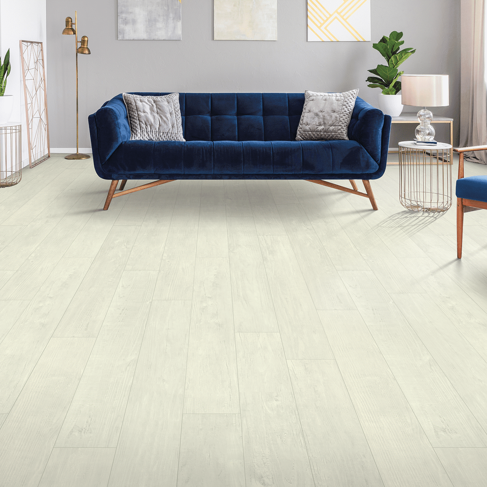 A living room with blue furniture and white walls.