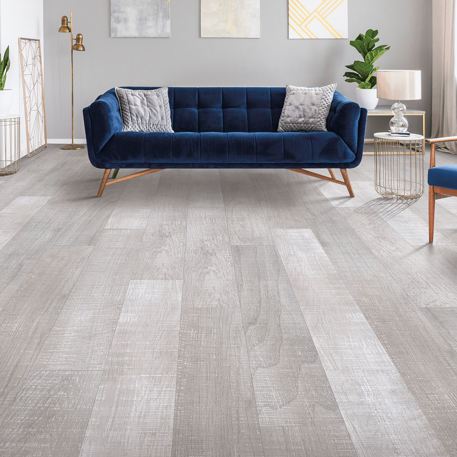 A living room with blue couch and white walls.