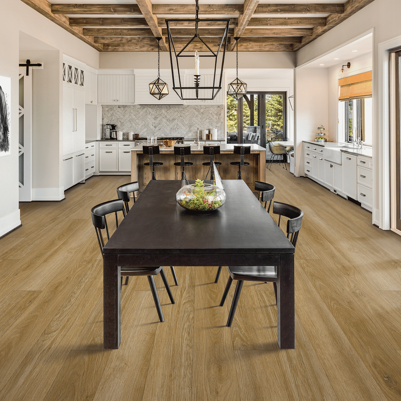 A large dining room with wooden floors and white walls.