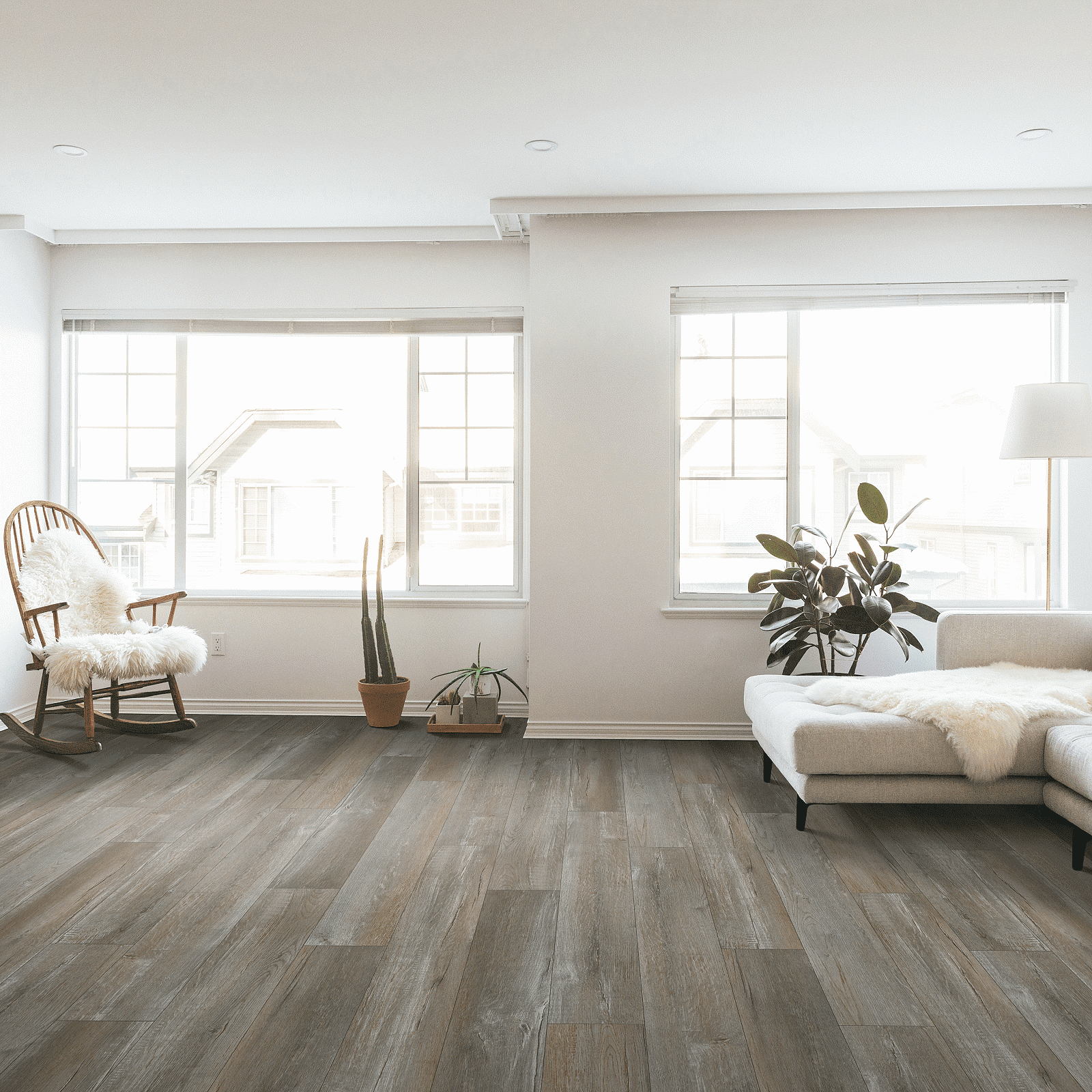 A living room with white walls and wooden floors.