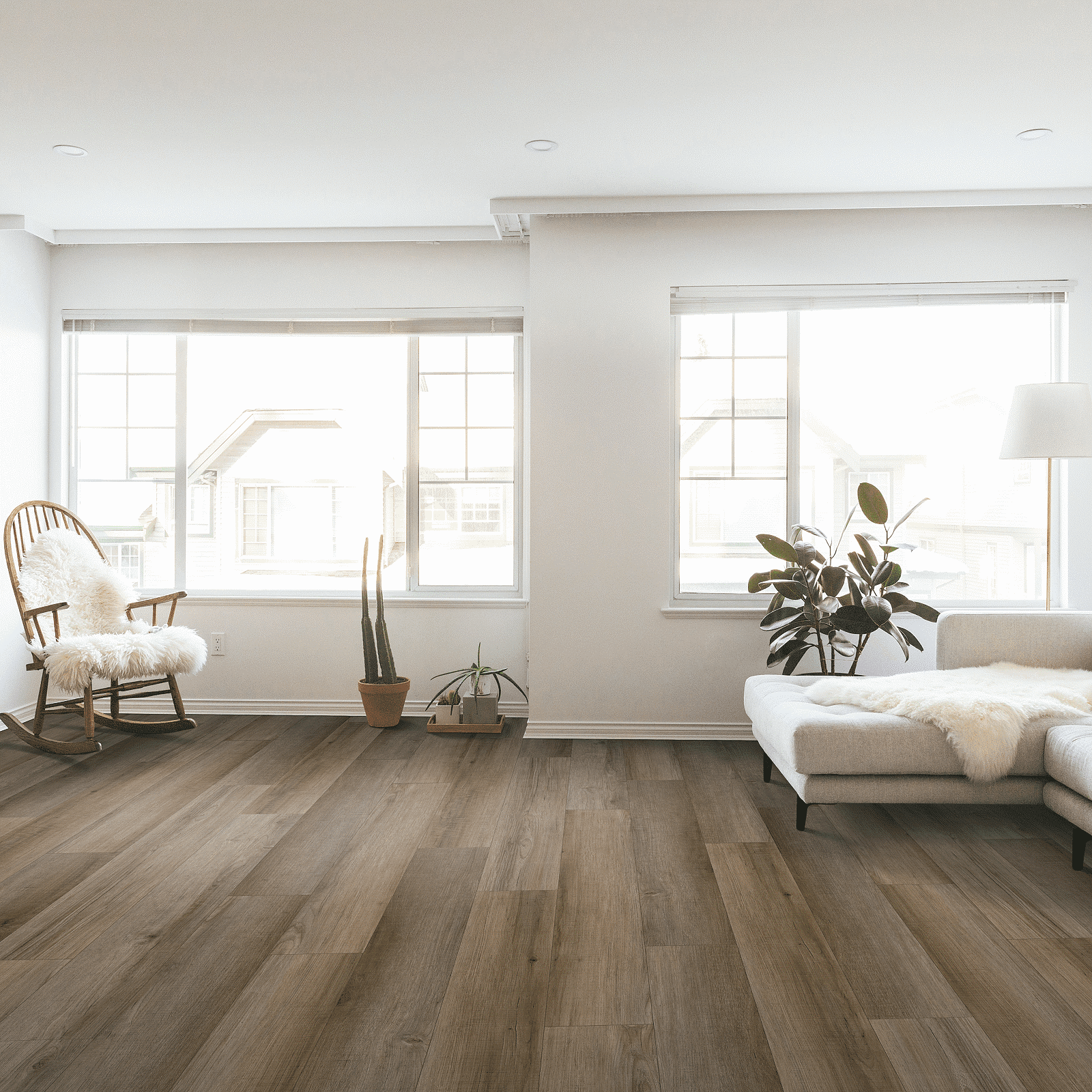 A living room with hard wood floors and white walls.