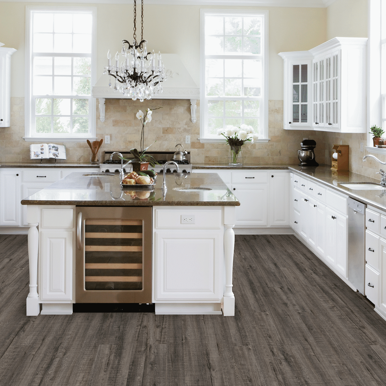 A kitchen with white cabinets and brown floor