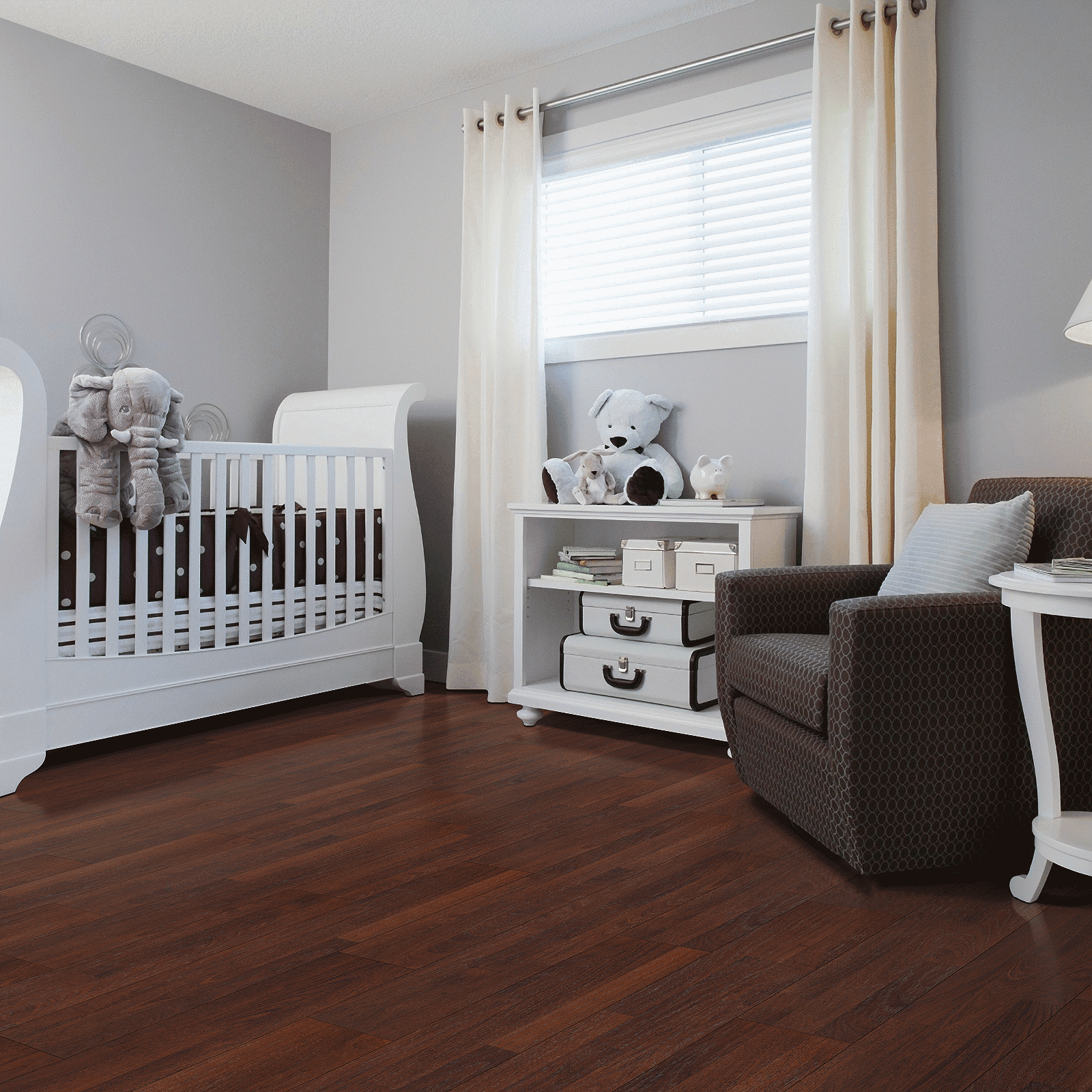 A baby room with a crib, chair and table.