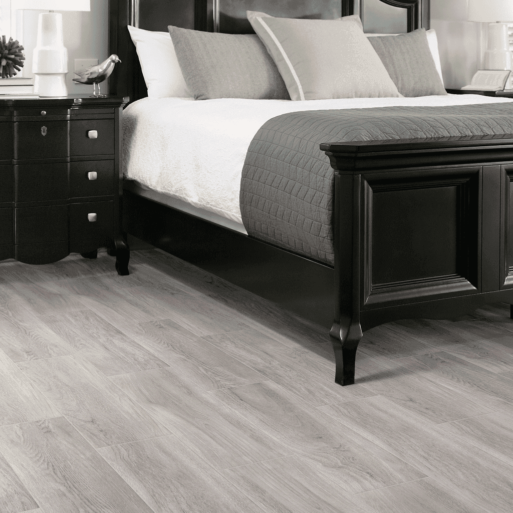 A bedroom with a bed and nightstand in it