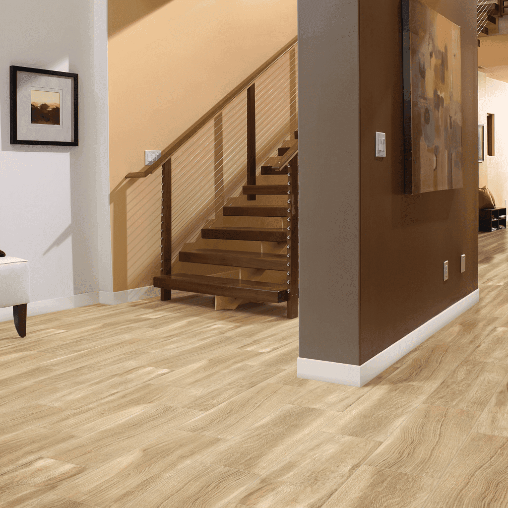 A room with stairs and a painting on the wall.