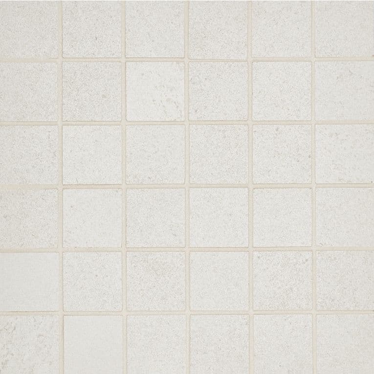 A white tile floor with some small squares