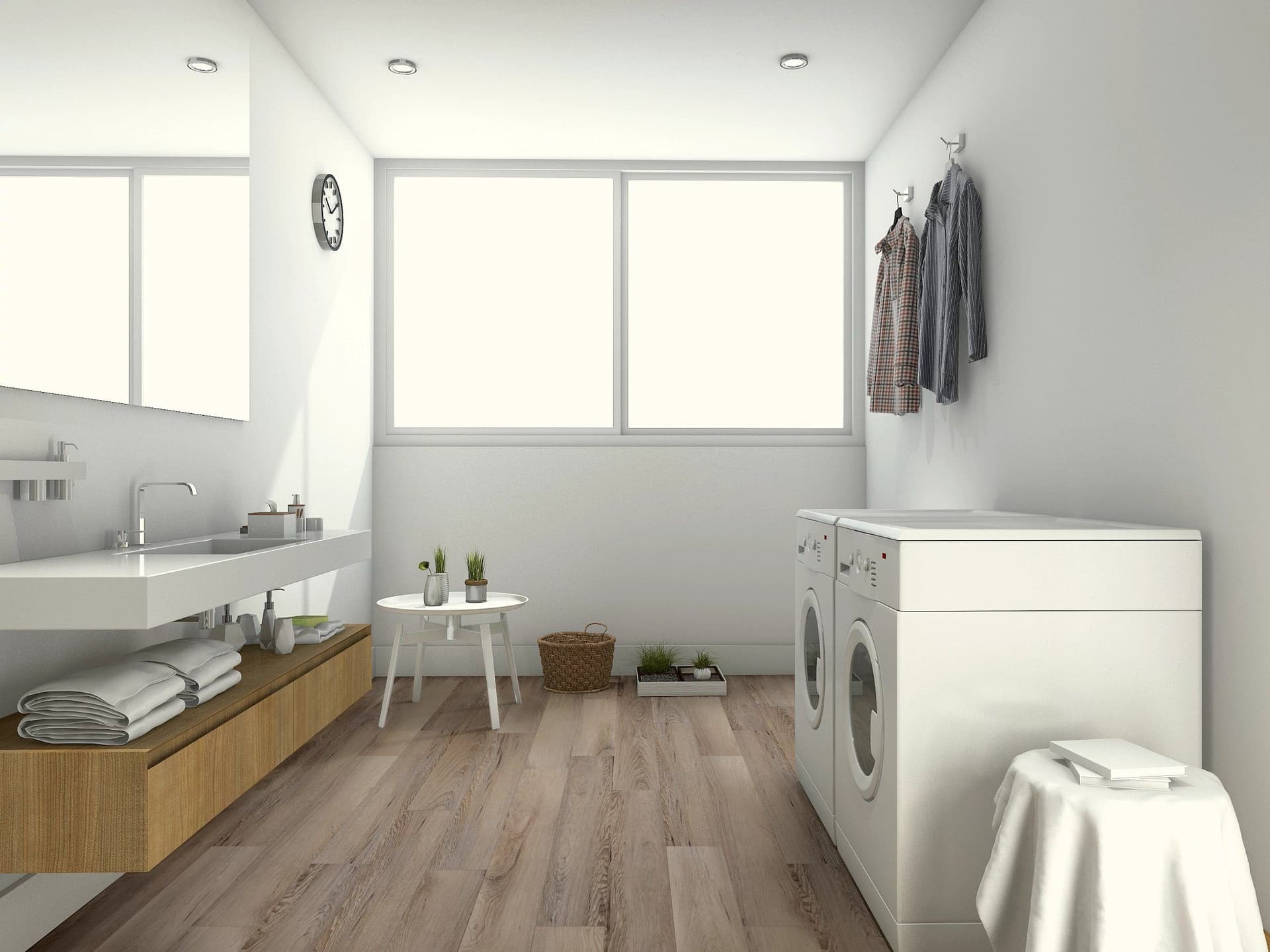 A bathroom with a sink, washer and dryer.