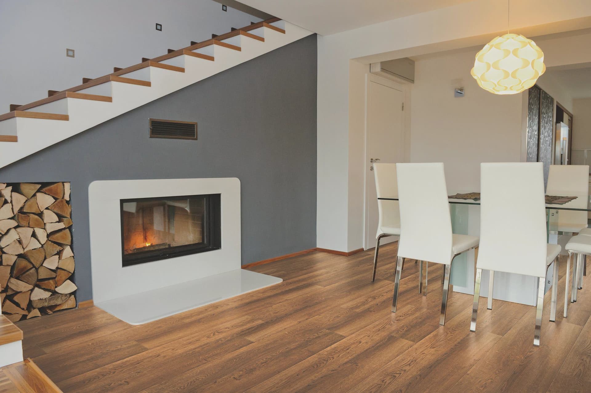 A room with a fireplace and wooden floors