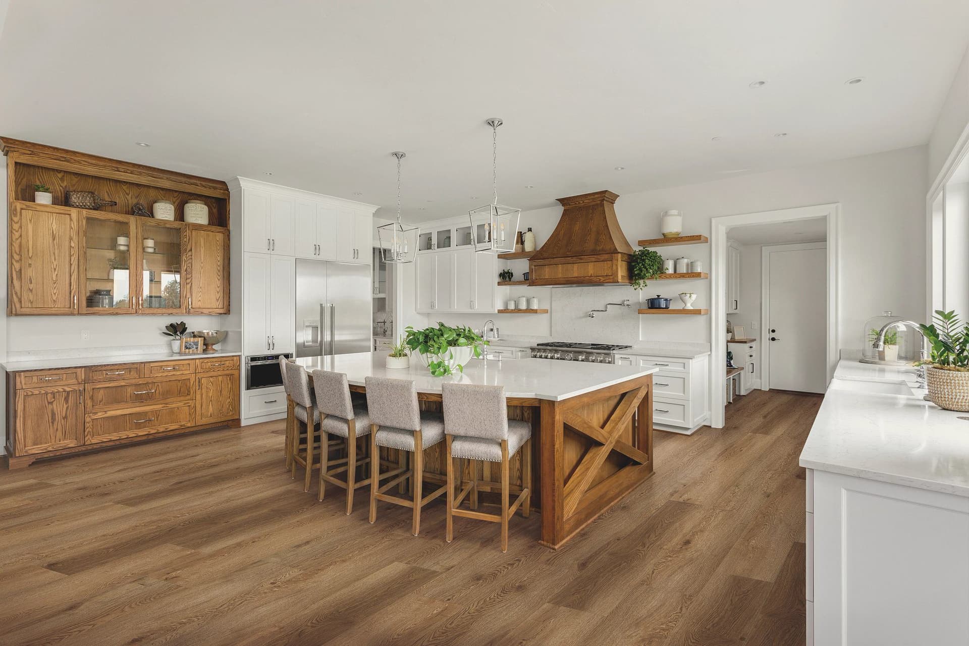 A kitchen with wooden floors and white walls.
