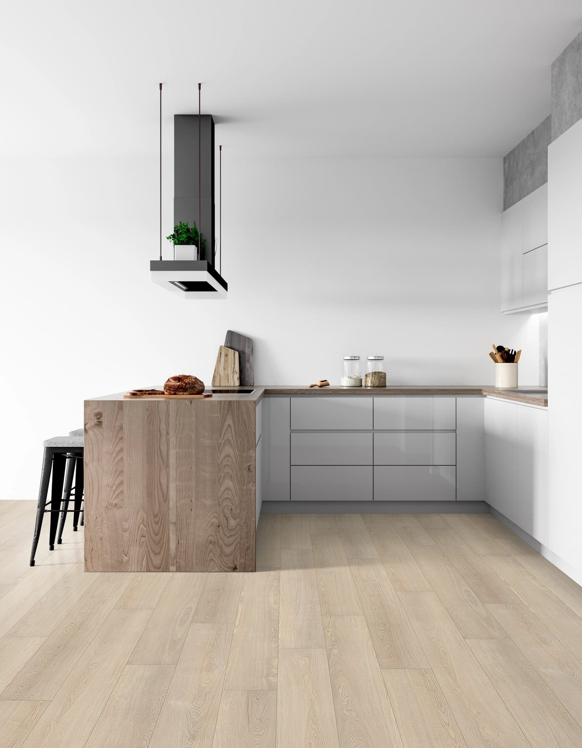 A kitchen with white walls and wooden floors.