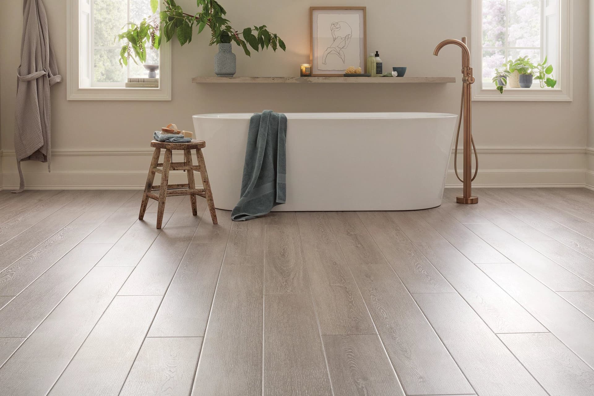 A bathroom with wooden floors and white walls.