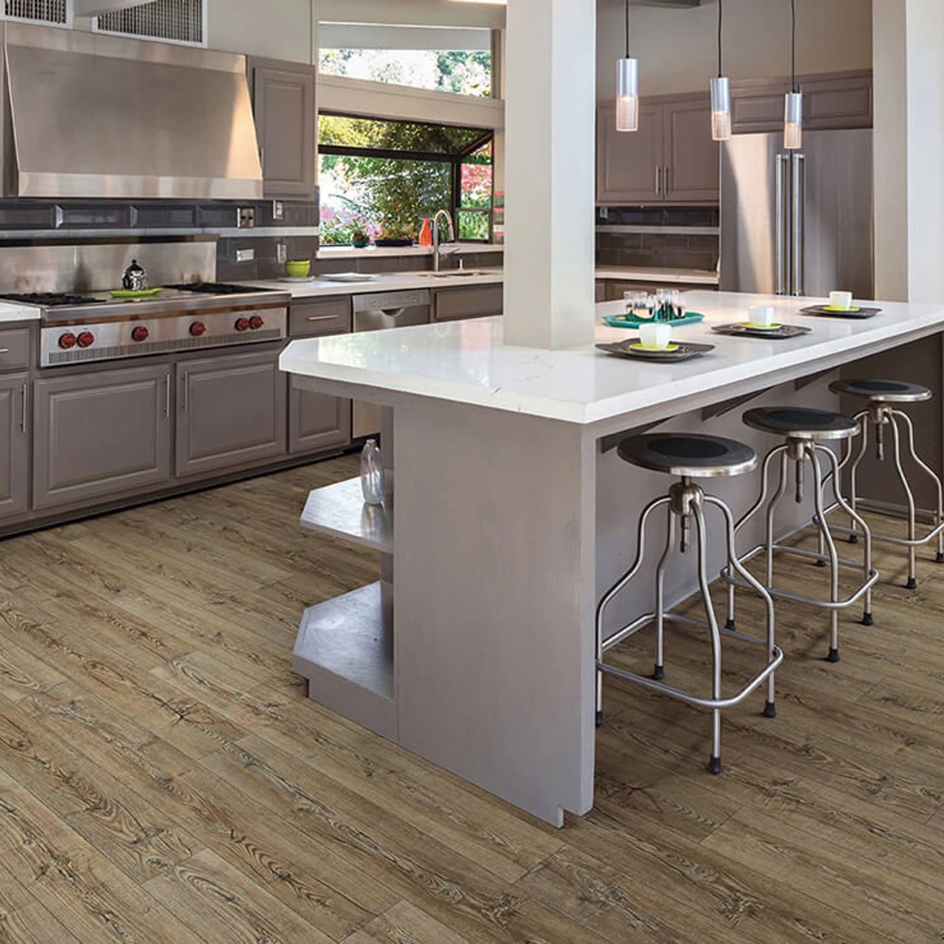A kitchen with a large island and white cabinets.
