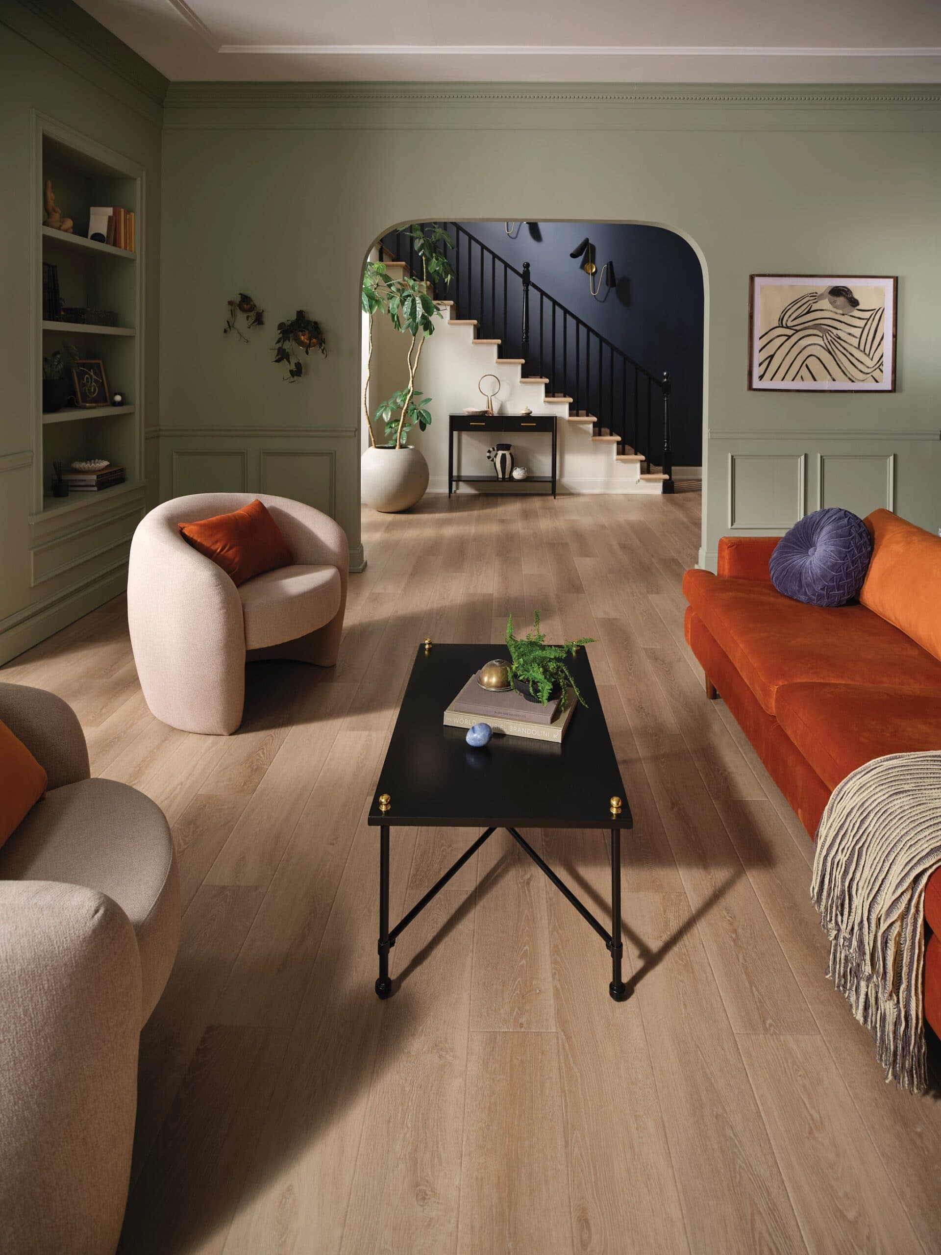 A living room with hard wood floors and furniture.