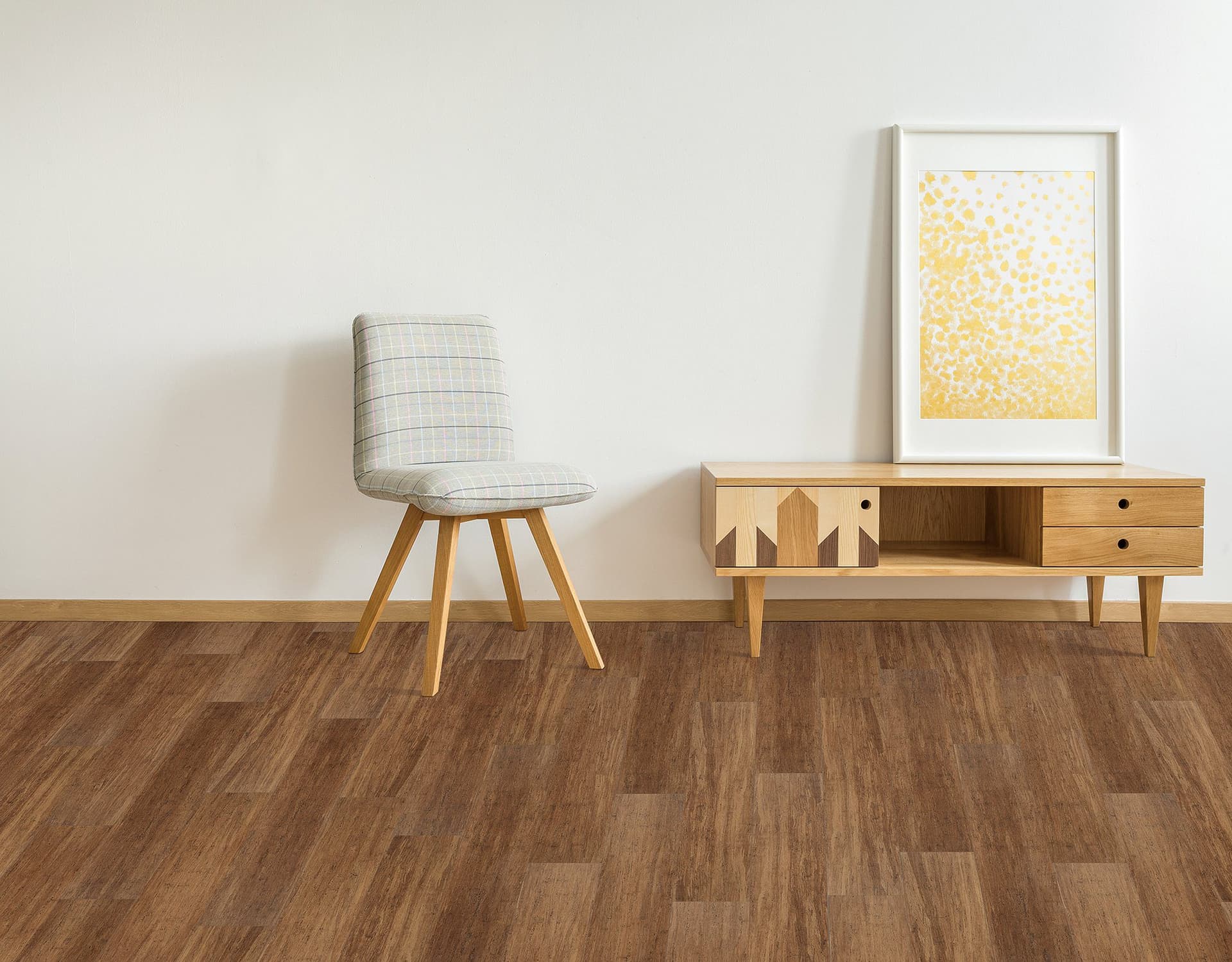 A chair and table in a room with wood floors.