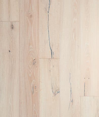 A white wood floor with some cracks on it