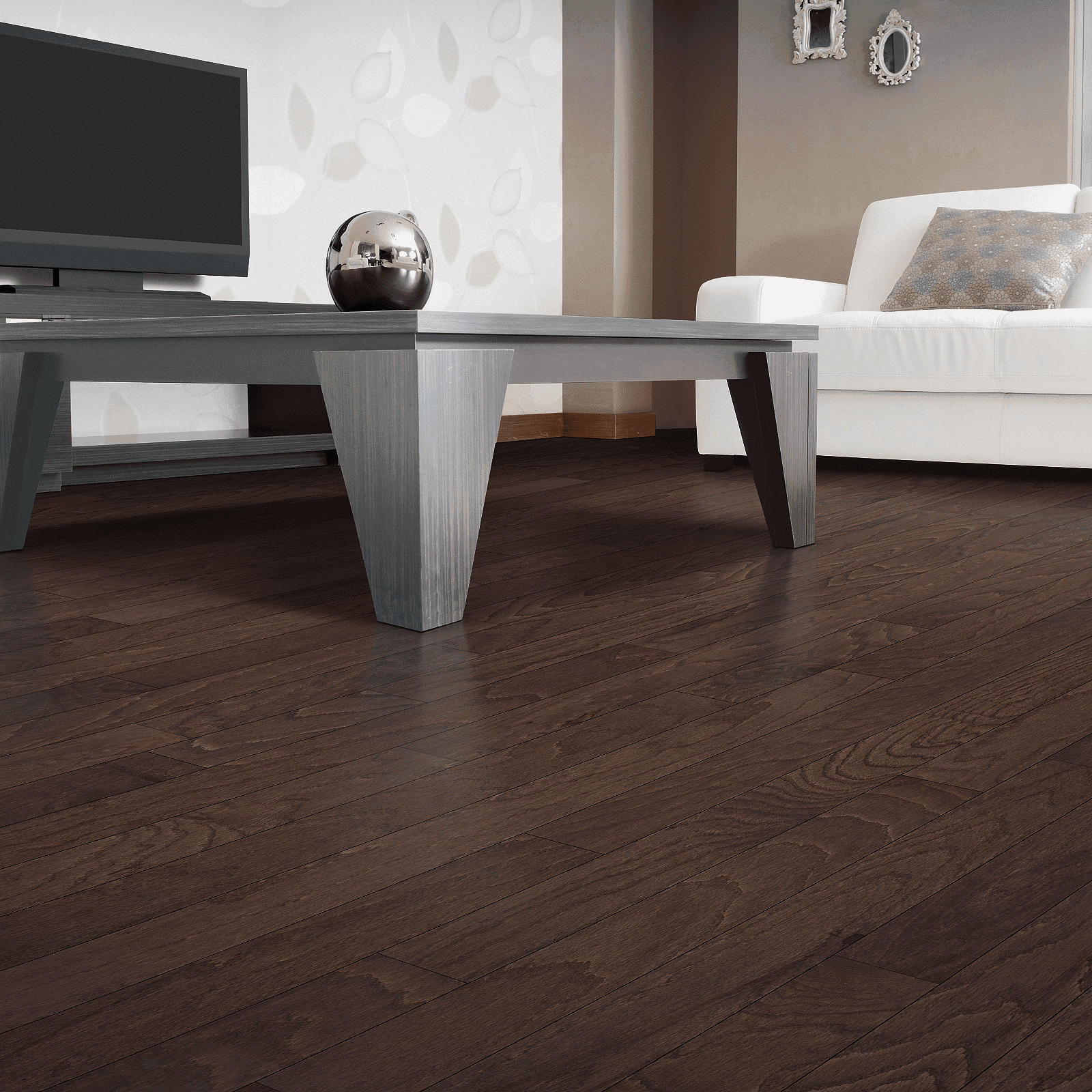 A living room with dark wood floors and white furniture.