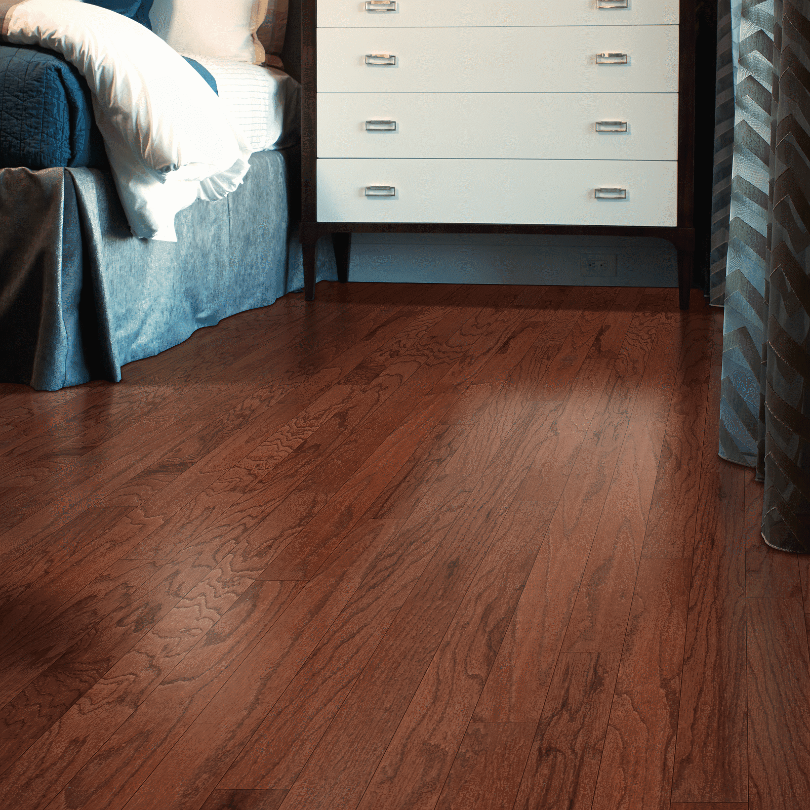 A bedroom with hardwood floors and a bed.