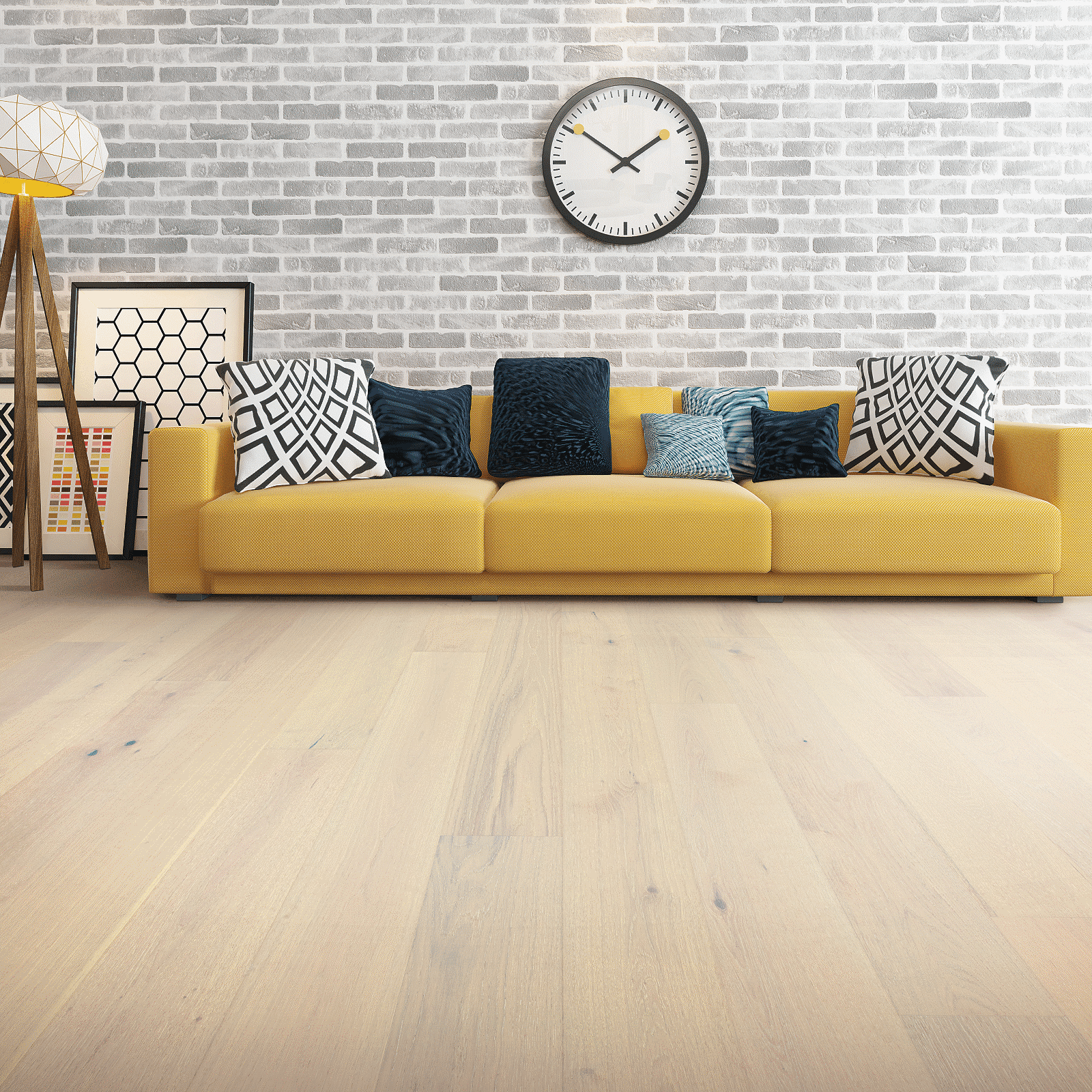 A yellow couch sitting in front of a white brick wall.