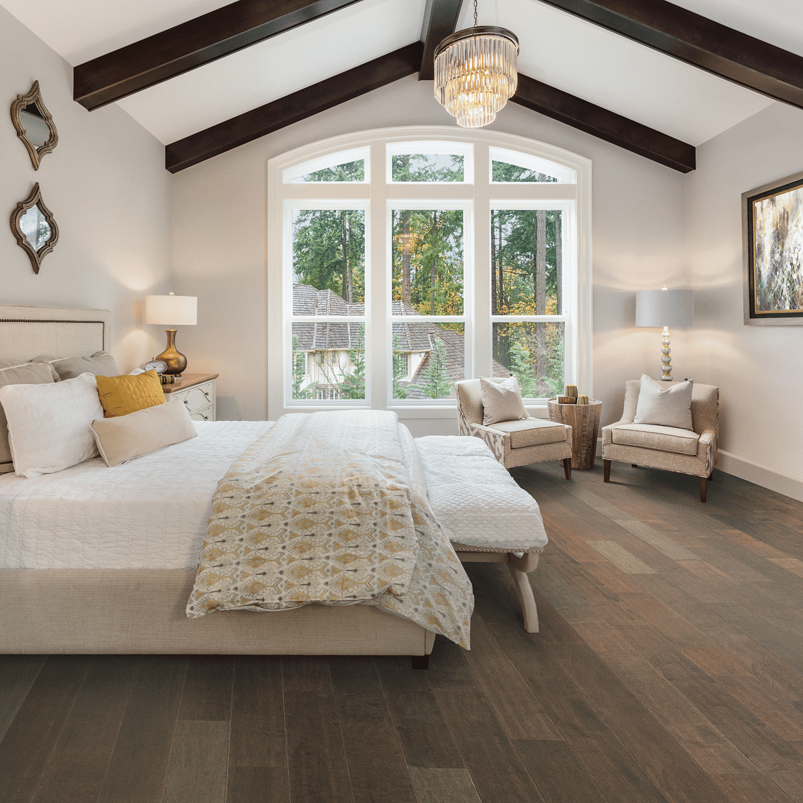 A bedroom with two large windows and a bed.