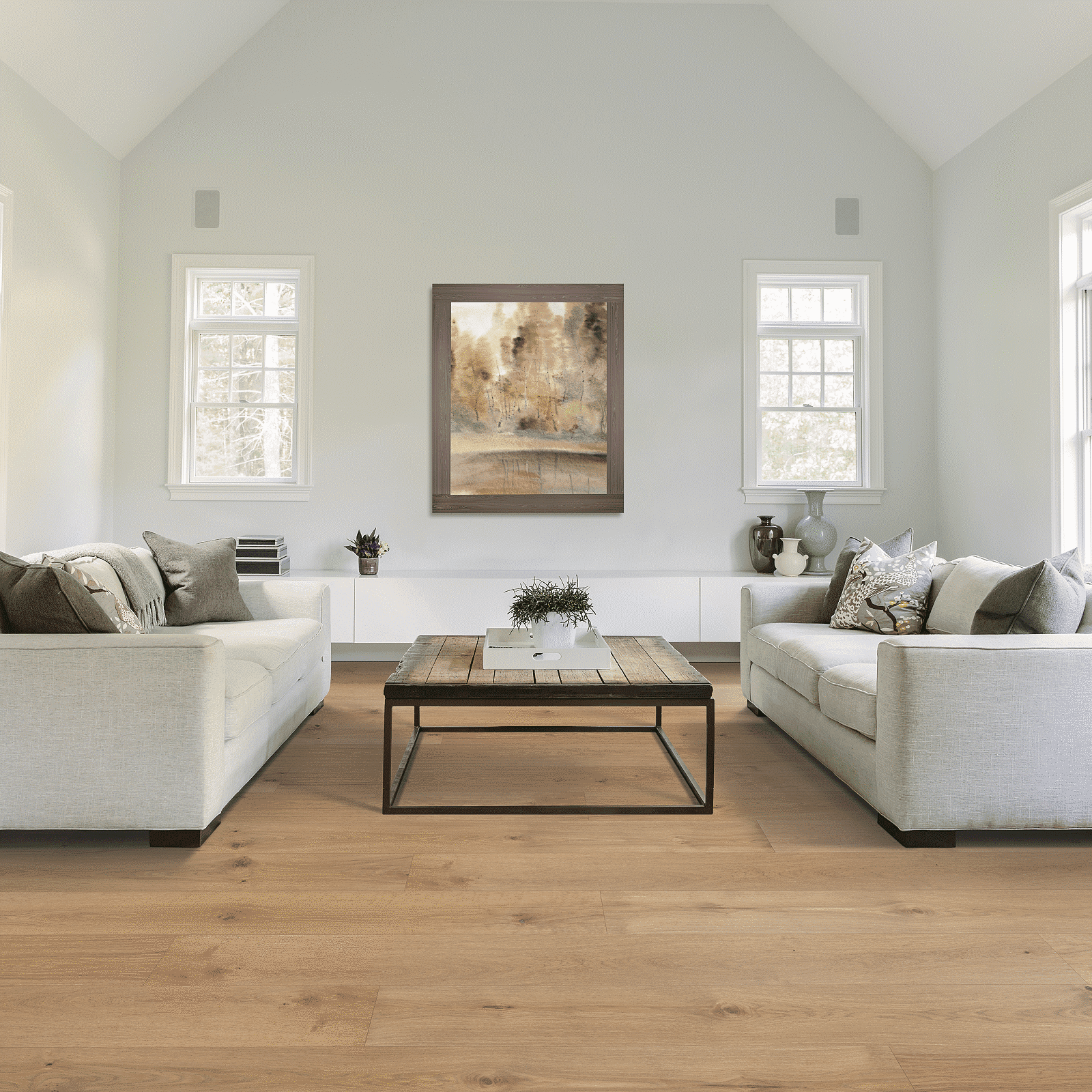 A living room with white couches and a coffee table.