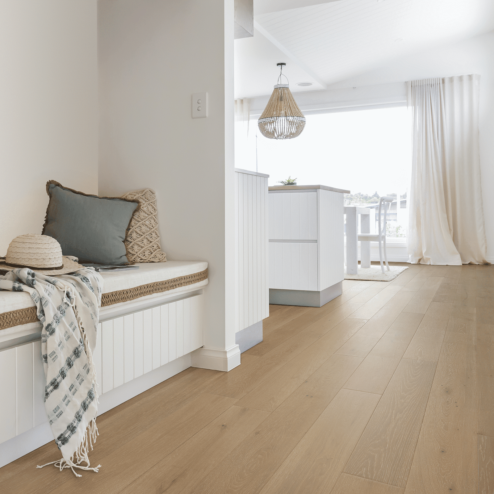 A room with a bench and pillows on it