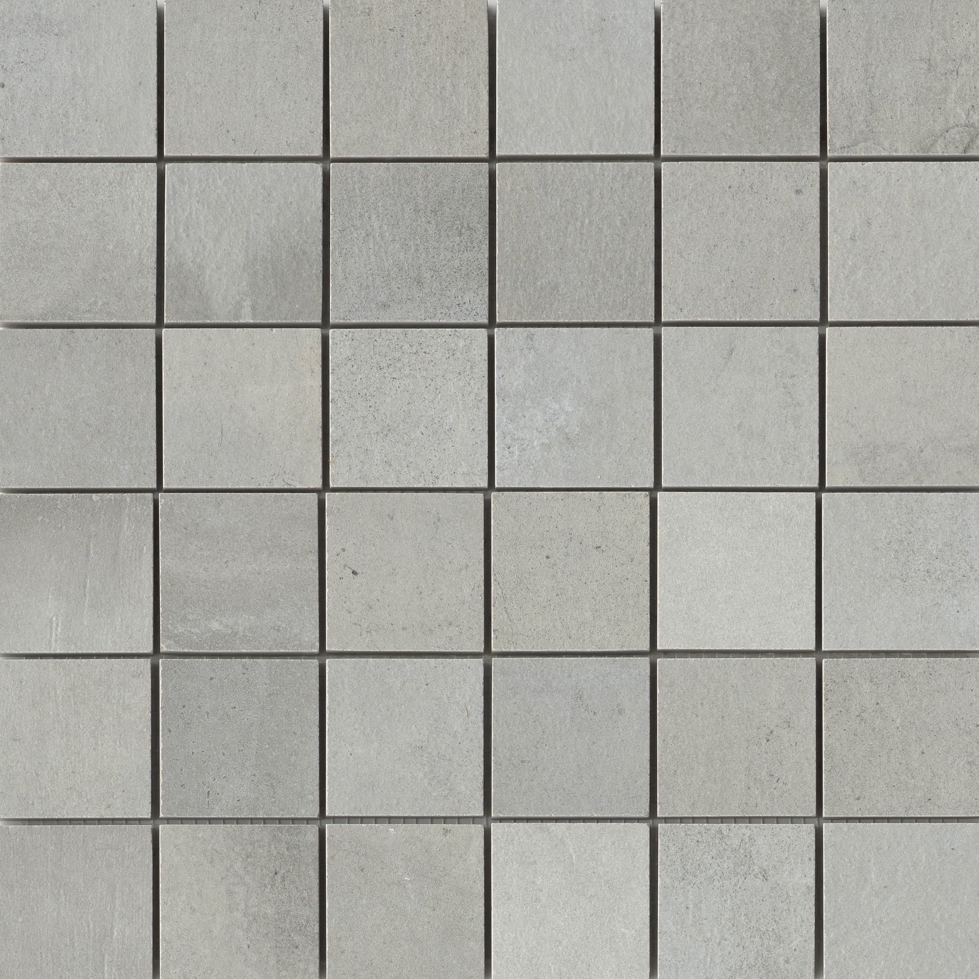 A square tile pattern that is gray and has some type of design.