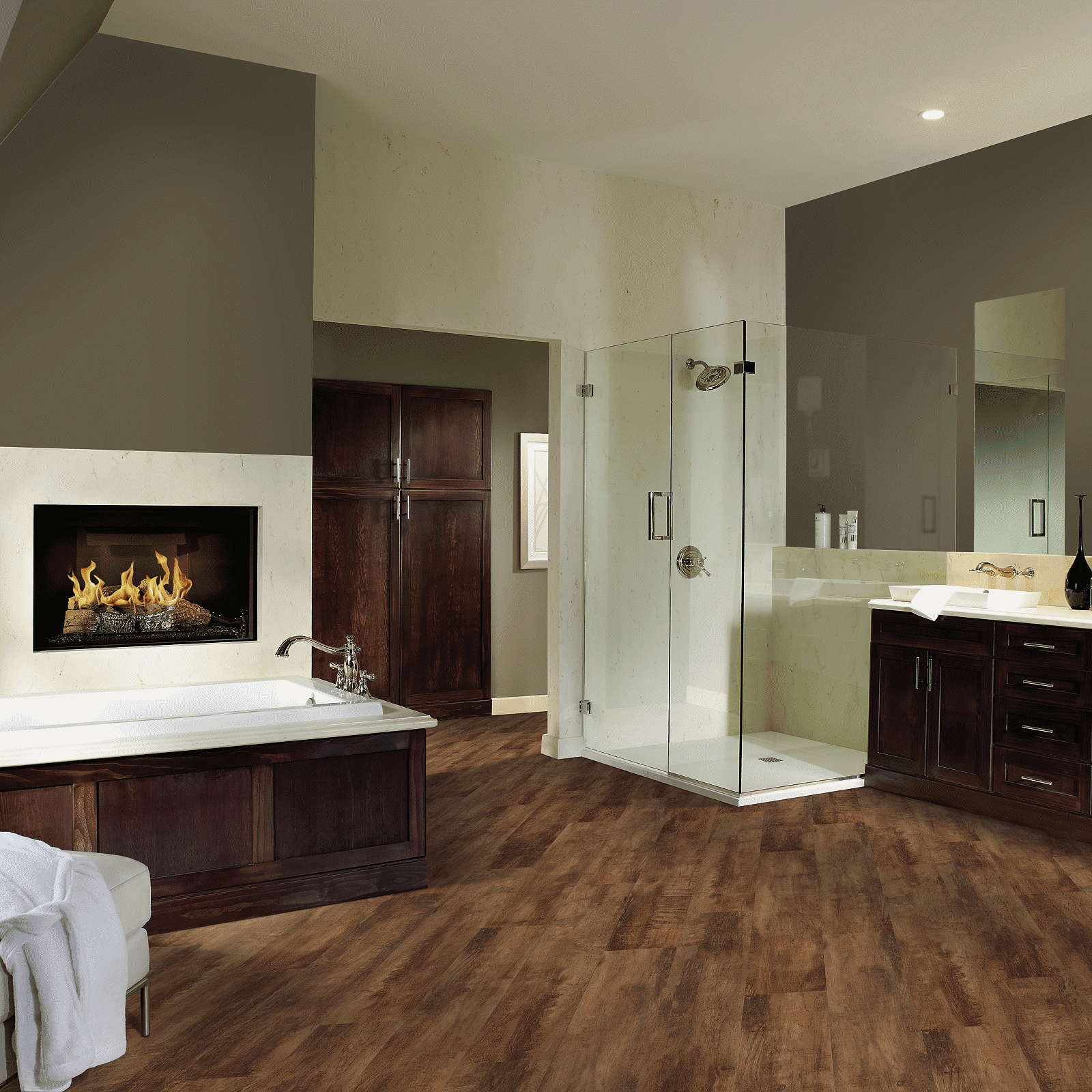 A bathroom with wood floors and a fireplace.