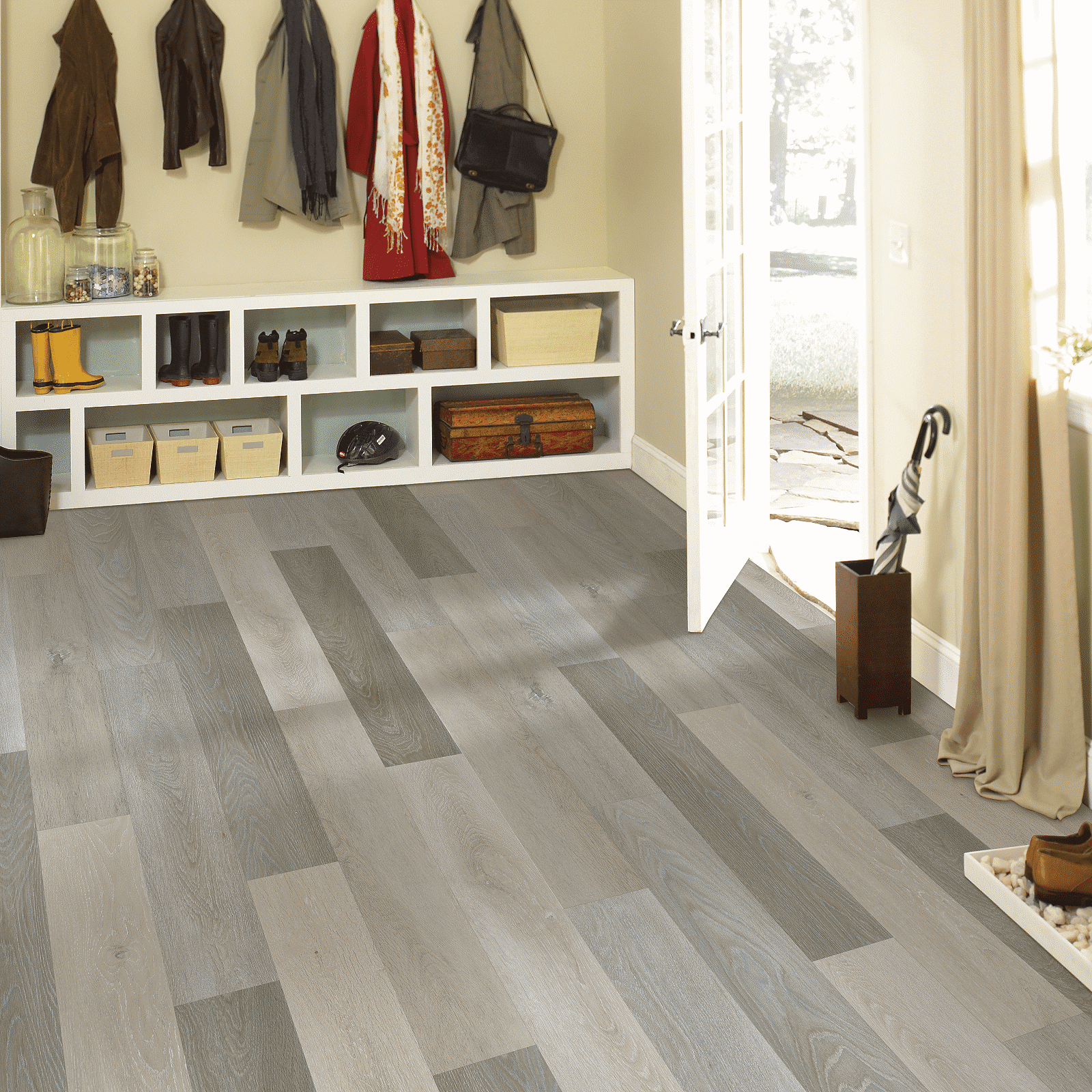 A room with many coats hanging on the wall.