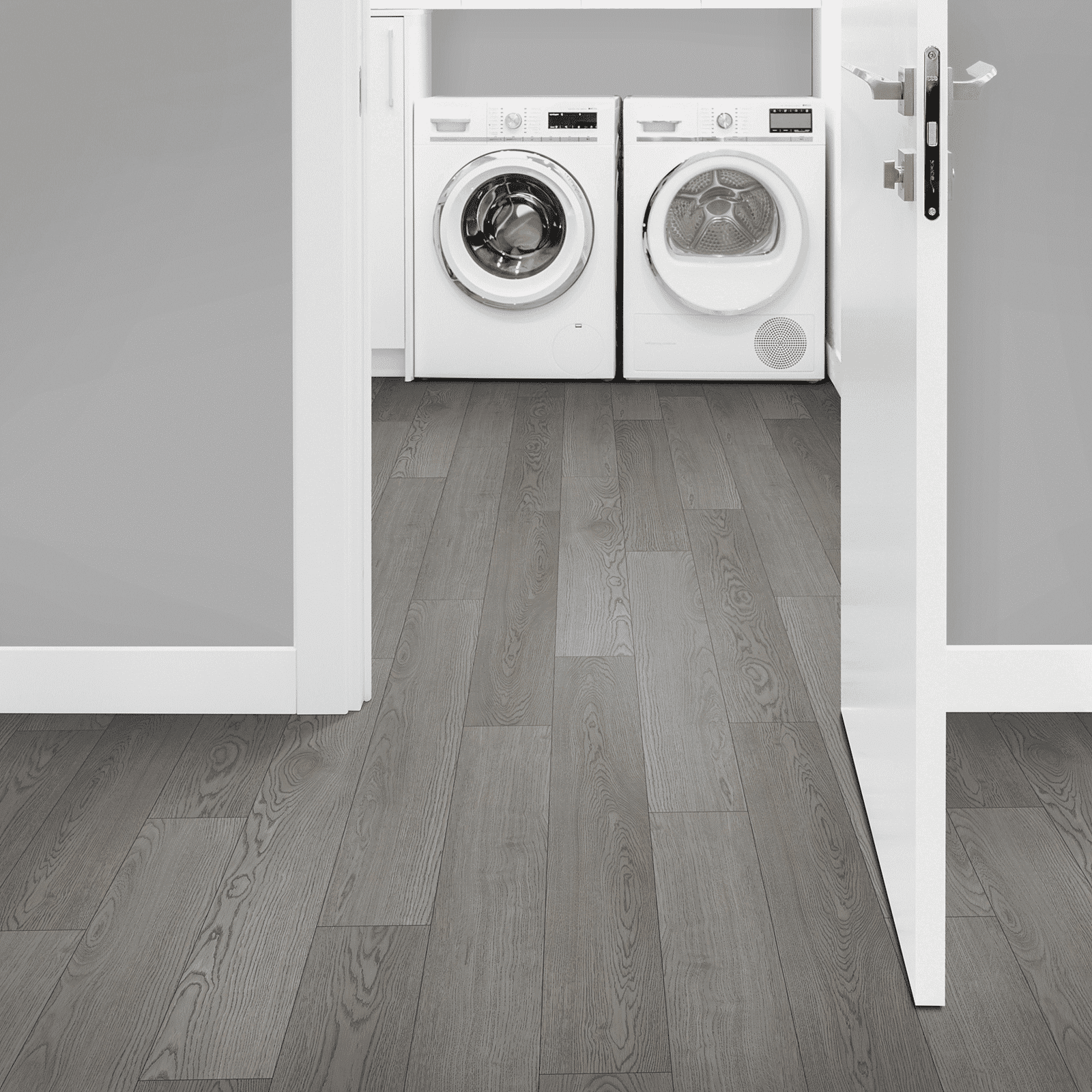 A view of two washing machines from the doorway.