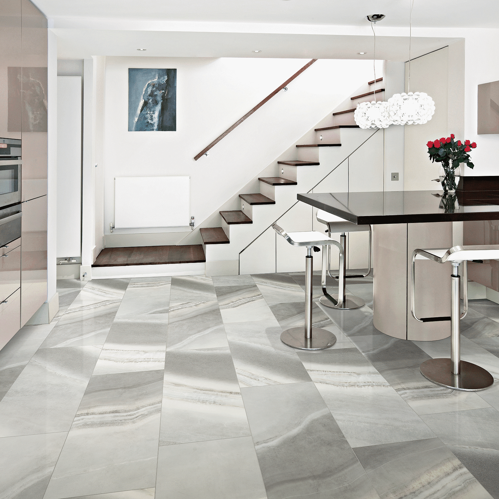 A kitchen with marble floors and stairs