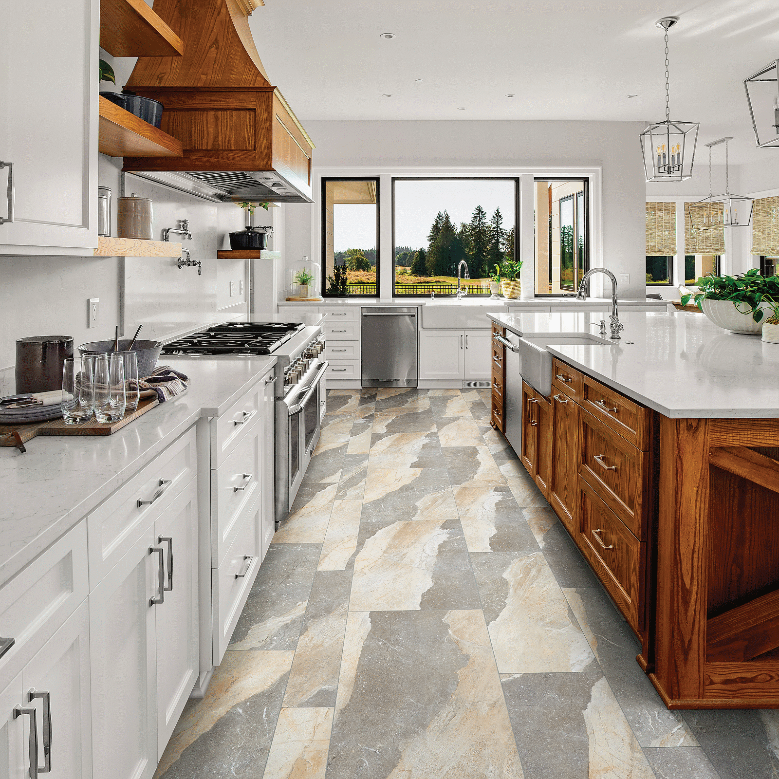 A kitchen with white cabinets and marble counter tops.