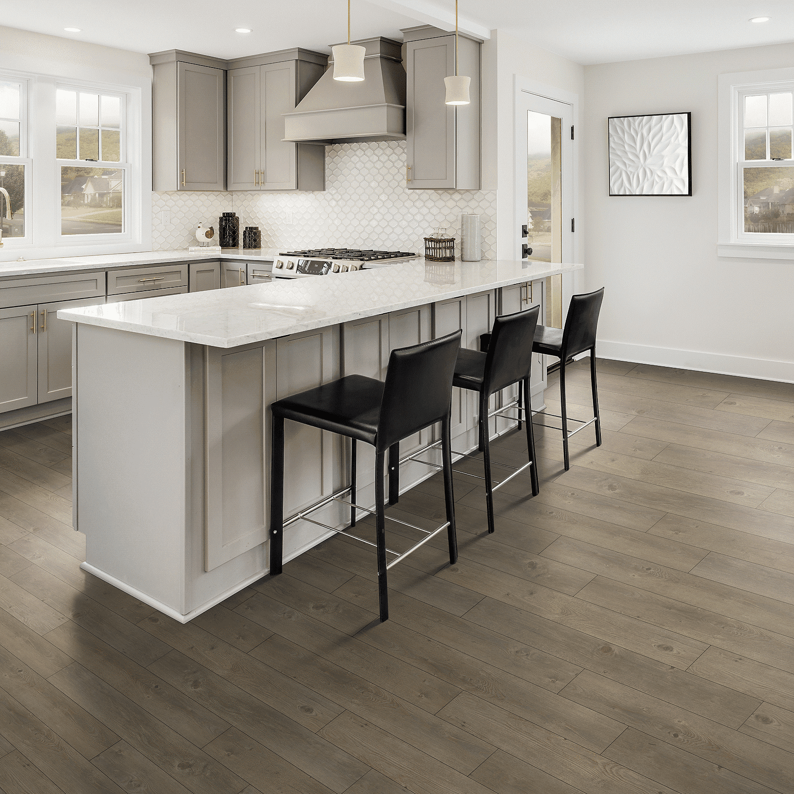 A kitchen with an island and black chairs.