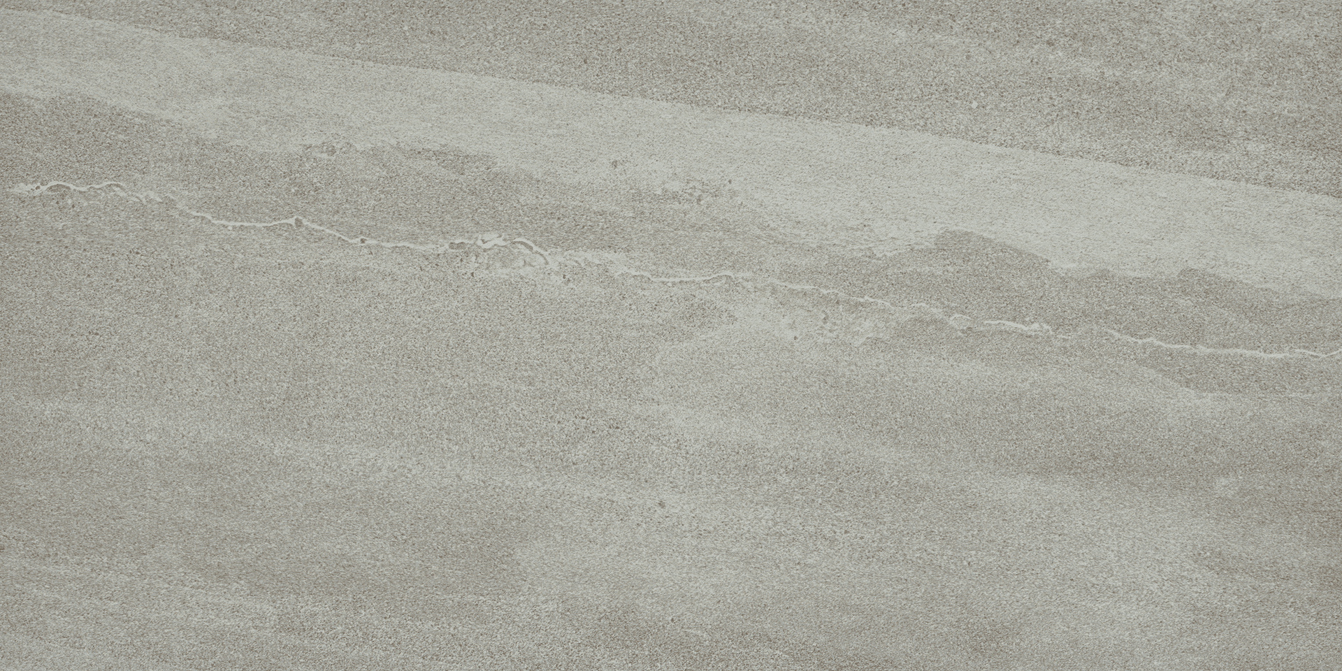 A gray sky with some clouds and a bird flying