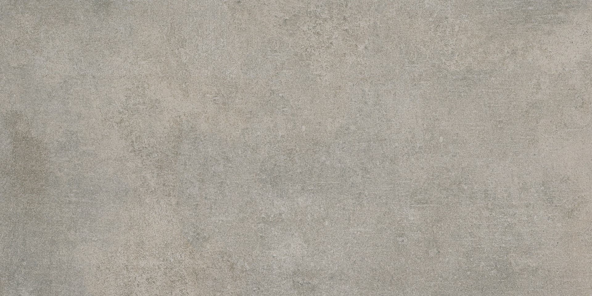 A gray concrete floor with some white spots