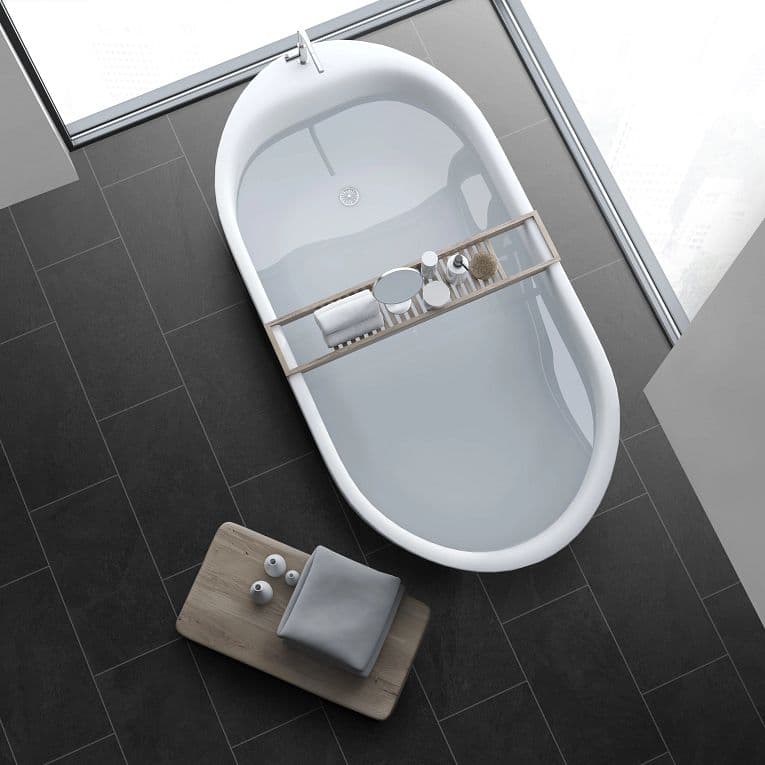 A white bathtub sitting on top of a black floor.