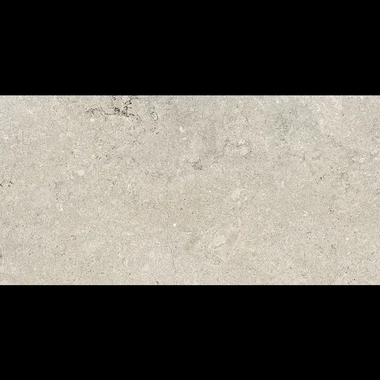 A white stone surface with some small rocks