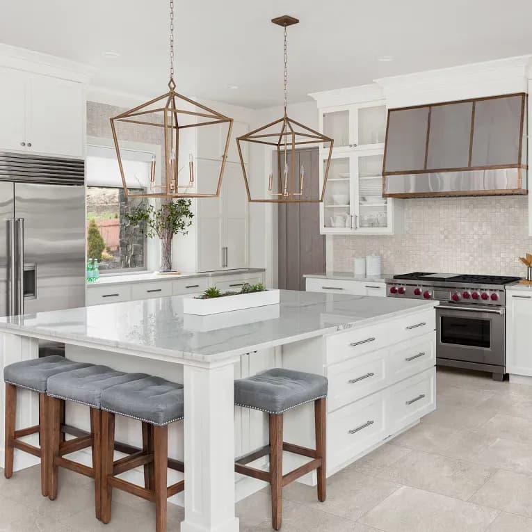 A kitchen with white cabinets and island in it